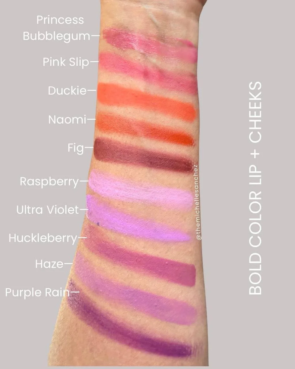 Swatch of colorful lip and cheek makeup shades on forearm, labeled from top to bottom: Princess Bubblegum, Pink Slip, Duckie, Naomi, Fig, Raspberry, Ultra Violet, Huckleberry, Haze, Purple Rain, with the text 'BOLD COLOR LIP + CHEEKS' on the right side.