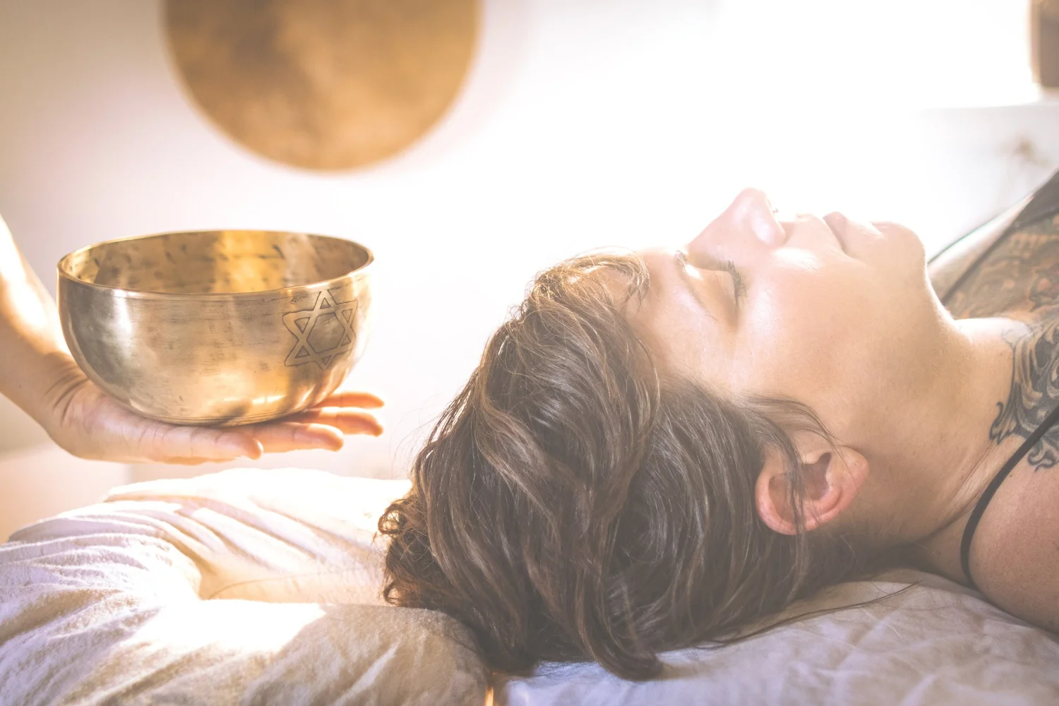 Crystal singing bowl resting on the body