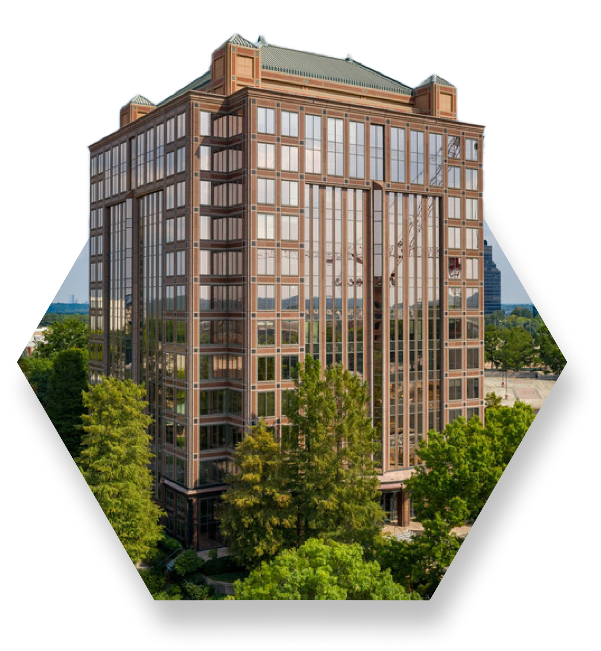 The ������ý building in Atlanta, Cobb Galleria. Modern multi-story office building with reflective glass windows surrounded by green trees in an urban area.