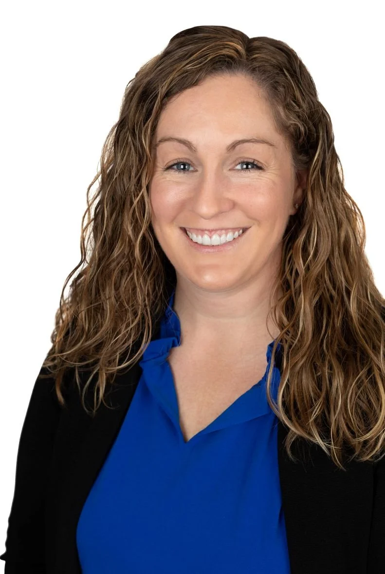 Jodi Hughes headshot: white woman smiling dark blond curly hair blue blouse black sweater