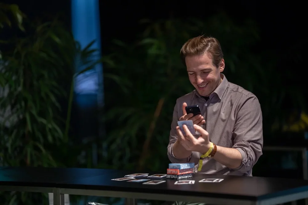 A man scanning the back of a FaithLabz AR card with his phone
