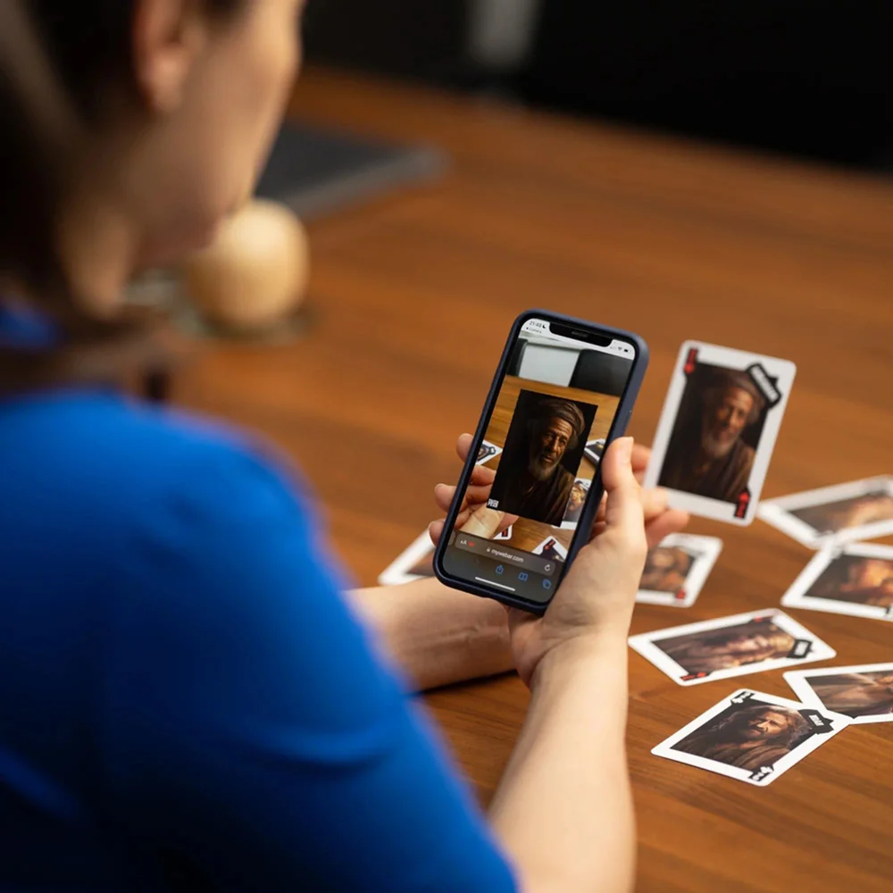 A woman scanning the face of an AR Bible card