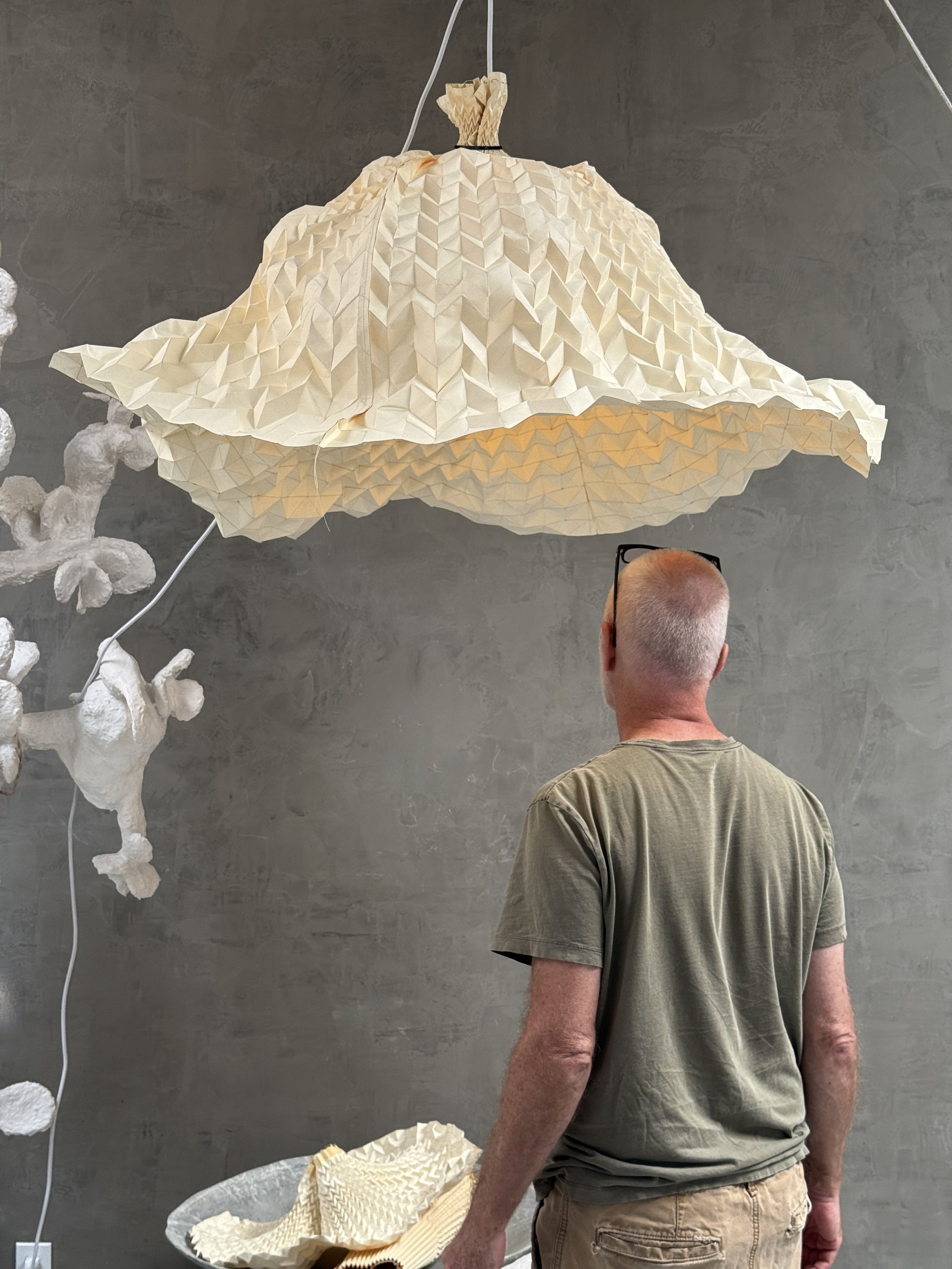 Tulip series by O.M. Studio. Designer working on light fixture in studio. Los Angeles.