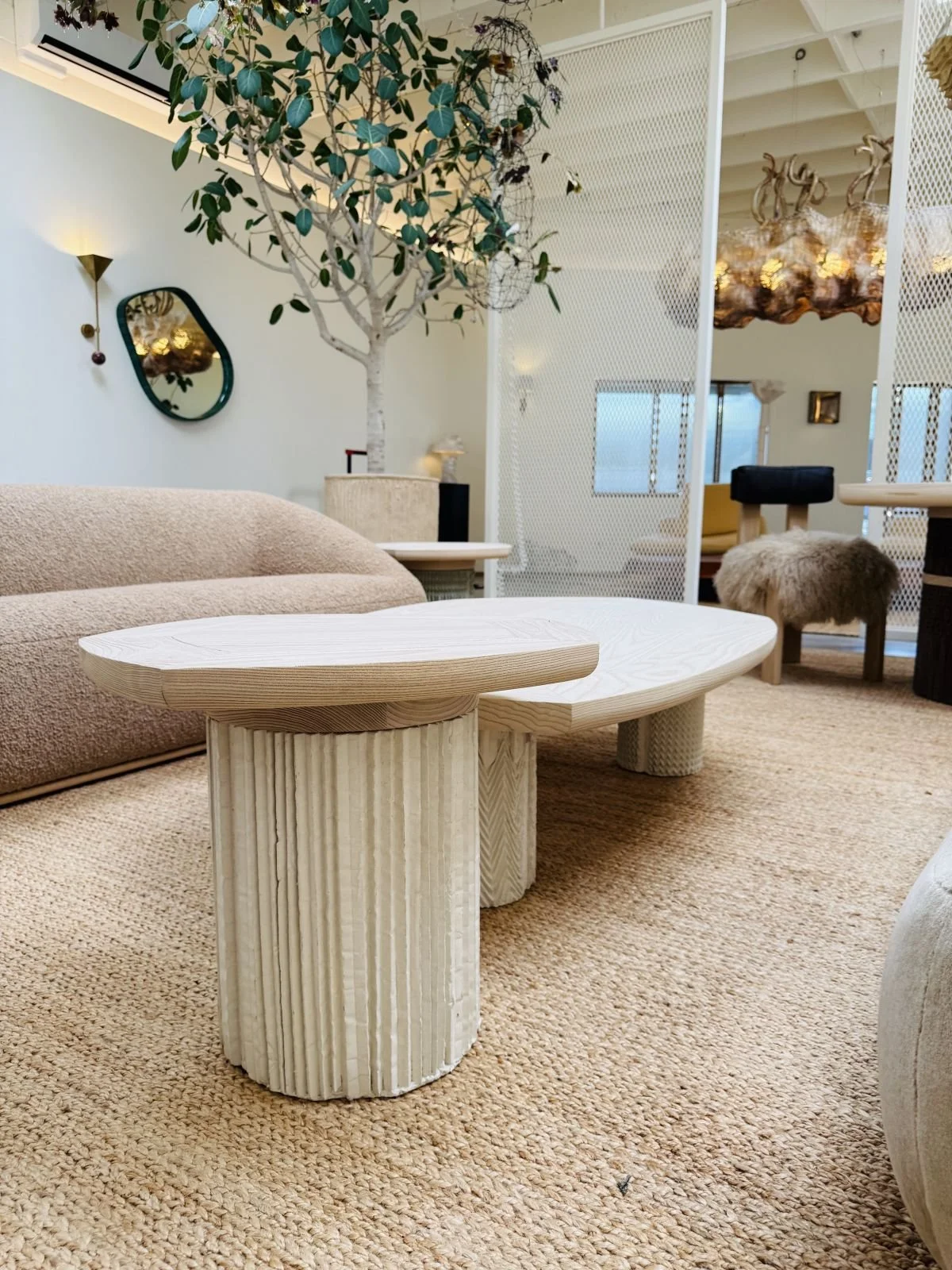 Plinth series of concrete table bases by O.M. Studio. Made from hand-scored pleating fabric paper. Side table and coffee table at Stahl + Band, Los Angeles.