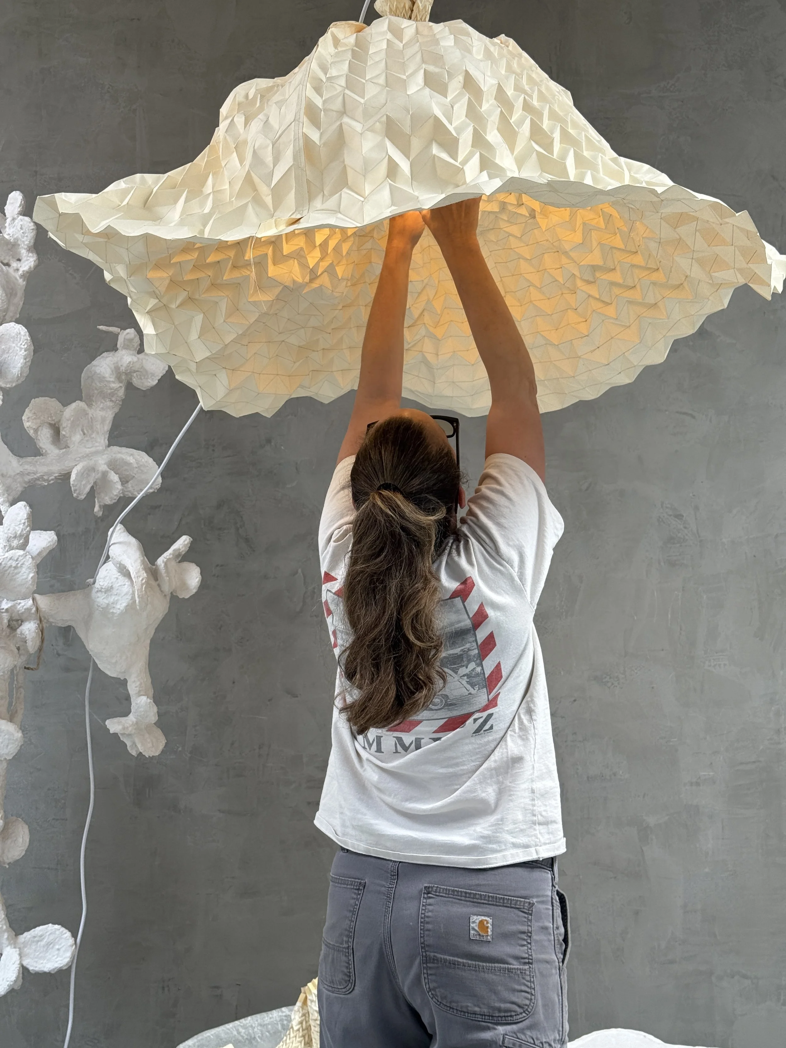 Tulip series by O.M. Studio. Designer working on light fixture in studio. Los Angeles.