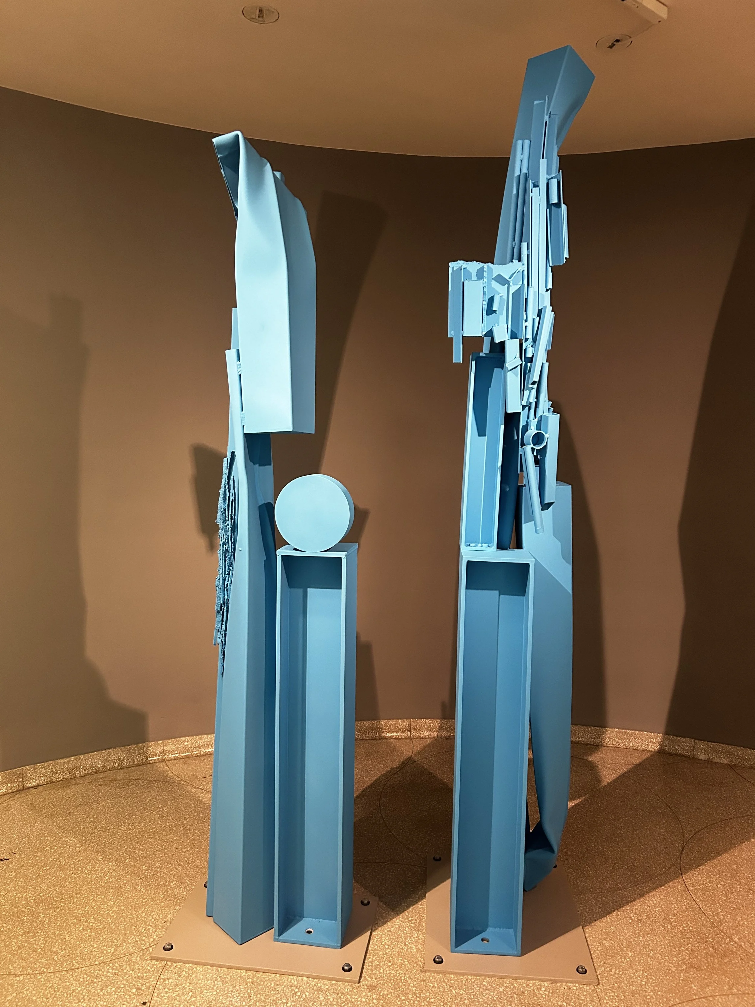  Left:   Second Blue Column  2016  Stainless steel and urethane paint  Private collection, Los Angeles   Right:  First Blue Column   2016  Stainless steel and urethane paint  Collection of Charlotte Feng Ford 