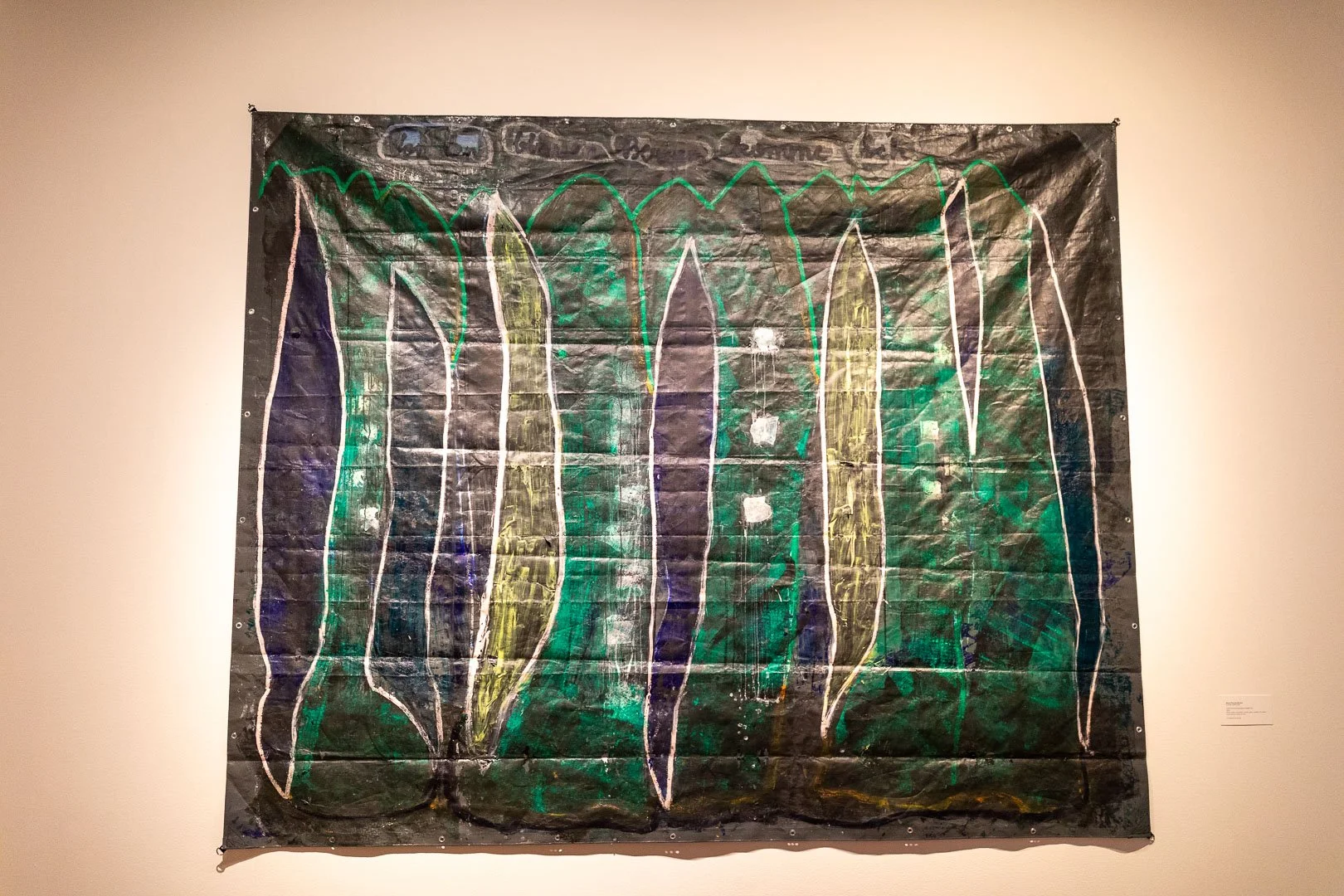  Maria Theresa Barbist  (b. Schwaz, Austria, 1979)  VON DEN BLAUEN BERGEN KOMME ICH, 2025  Mixed-media installation: acrylic paint, markers, oil sticks, and Polaroid transfer on  tarp  118 x 144 in.  Courtesy of the artist  Photography by Laura Serdi