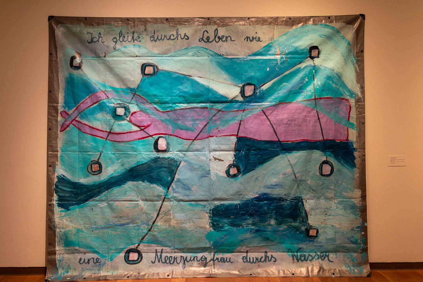  Maria Theresa Barbist  (b. Schwaz, Austria, 1979)  ICH GLEITE DURCHS LEBEN WIE EINE MEERJUNGFRAU DURCHS WASSER,  2025  Mixed-media installation: acrylic paint, oil stick, and Polaroid transfer on tarp  119 x 142 in.  Courtesy of the artist  Photogra