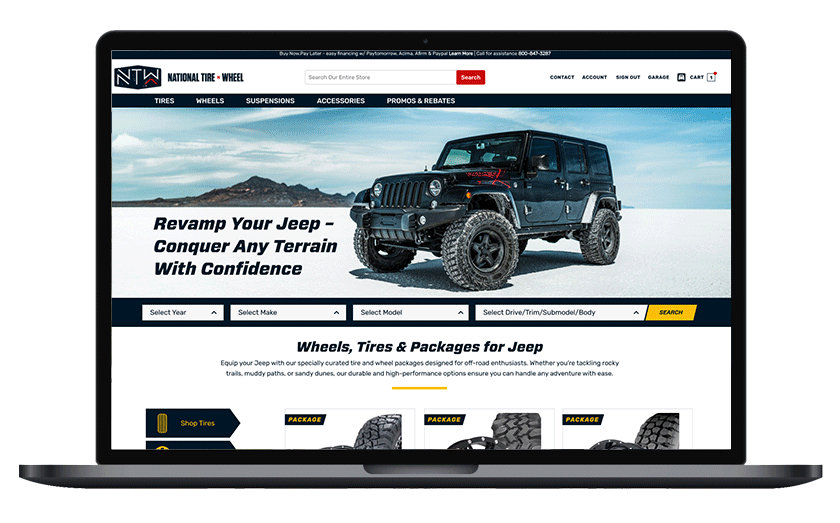 Laptop displaying an automotive website with a black Jeep in a desert landscape background, promoting off-road gear and tires.