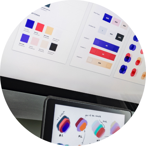 Color palettes and design swatches displayed on printed sheets and a tablet screen.
