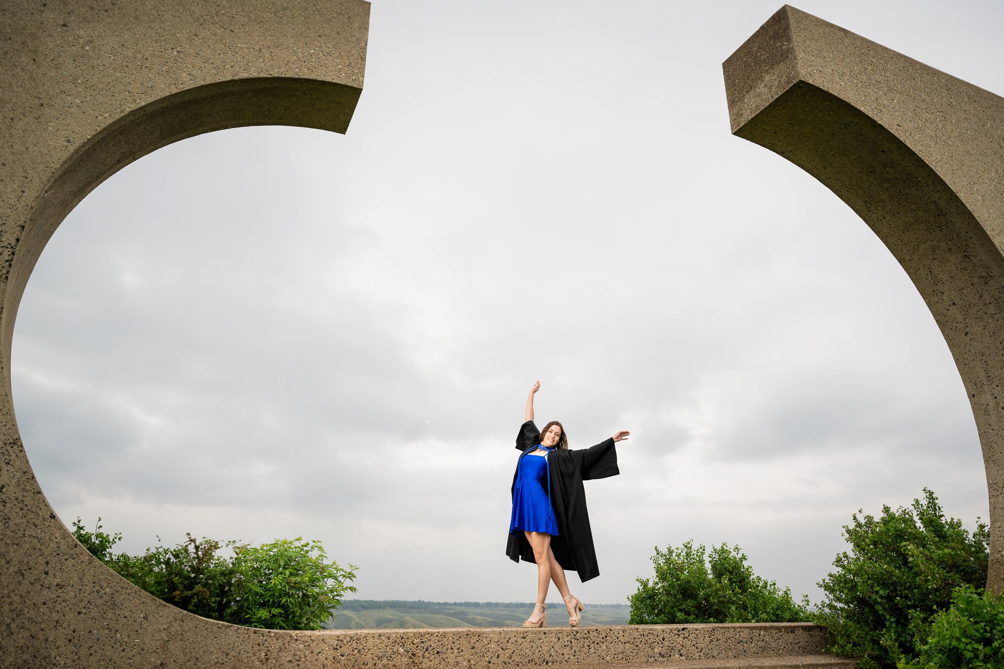 graduate at university of lethbridge posing for photo to celebrate