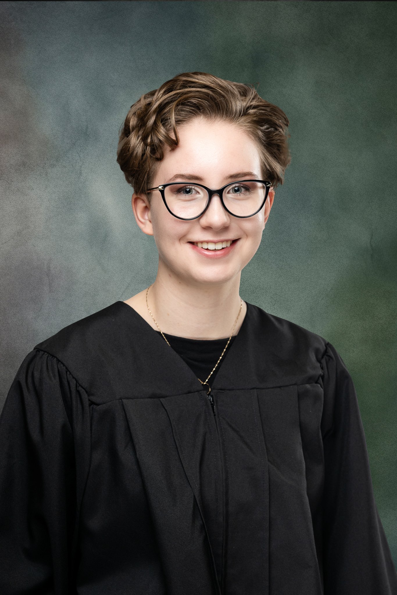 Studio grad headshot on green backdrop