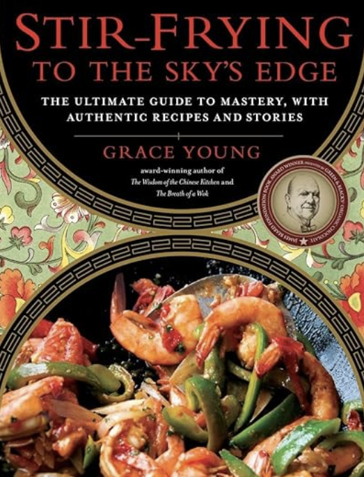 One of Judy's highly recommended books, the cookbook 'Stir-Frying to the Sky's Edge' by Grace Young featuring a dish of stir-fried shrimp, vegetables, and sauce.