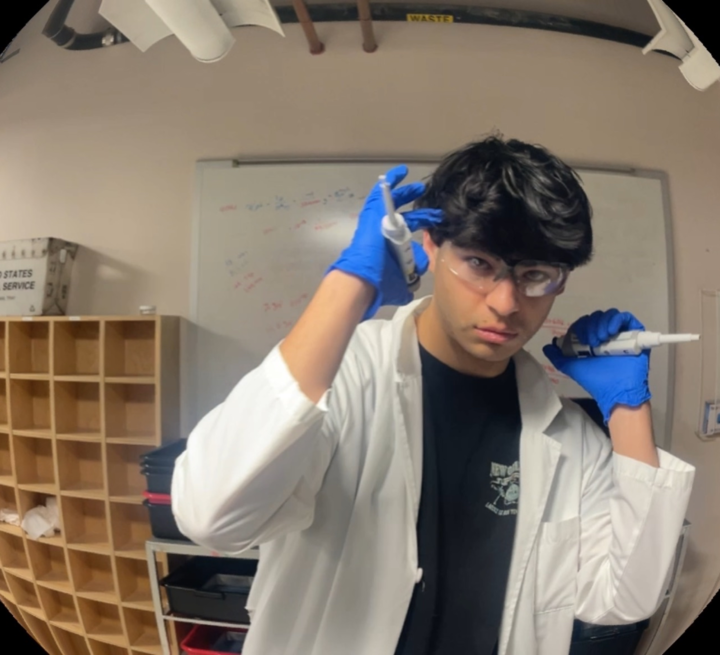 Michael holding pipettes reminiscent of a serial killer going after his prey