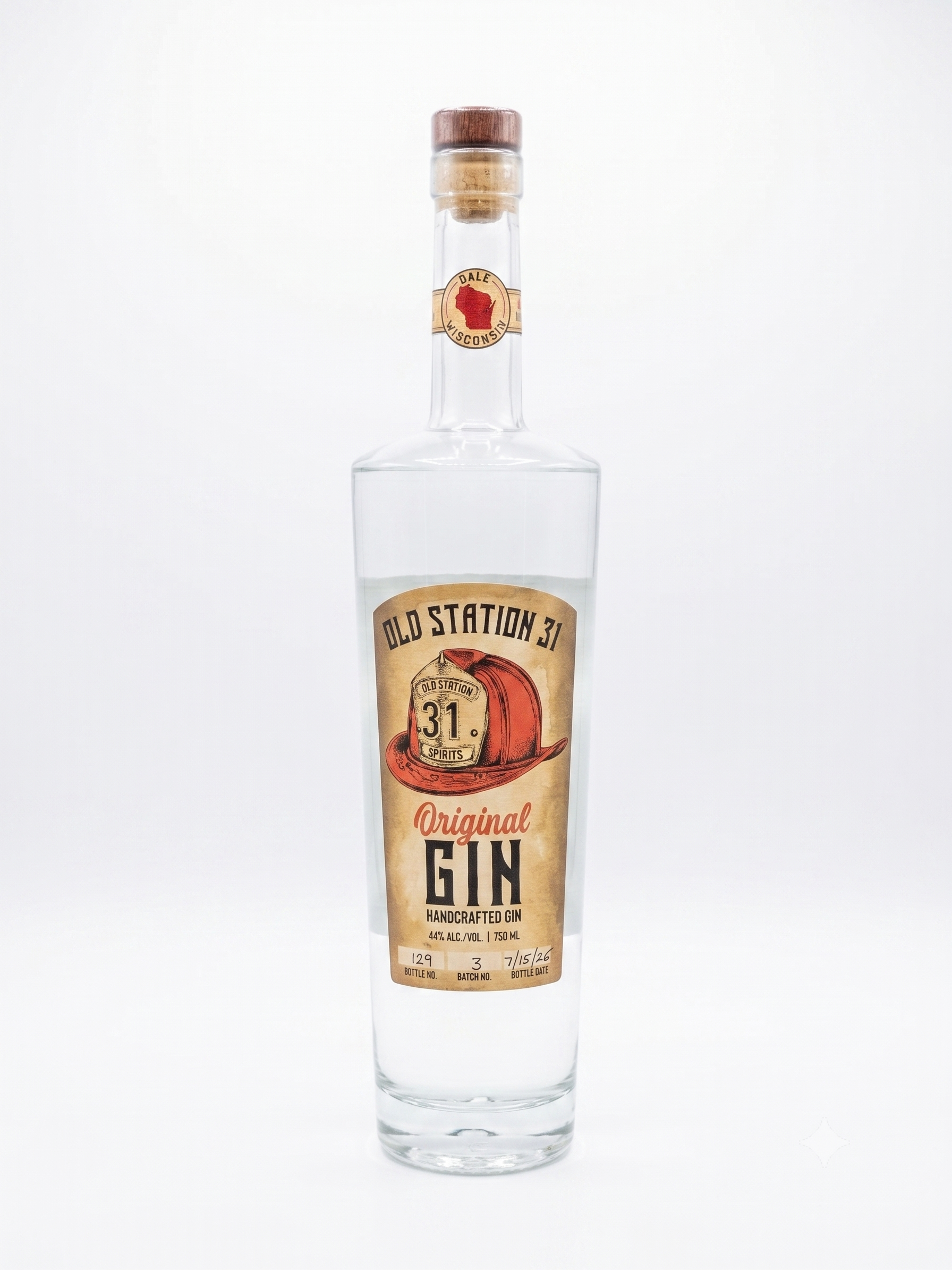 A clear glass bottle of Old Station 31 Original Gin with a beige label, red cowboy hat illustration, and black text, sealed with a wooden cap, against a plain white background.