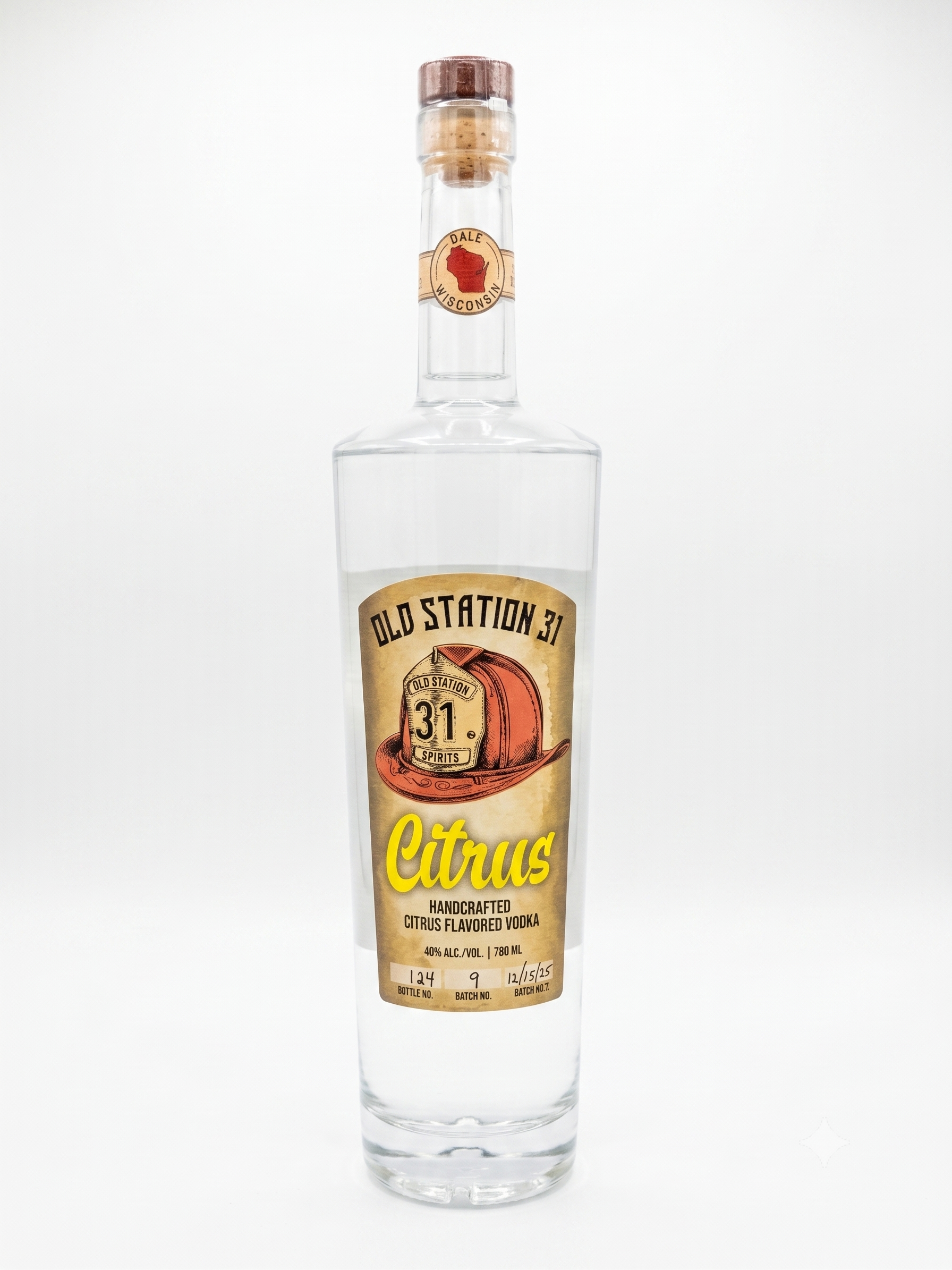 A tall, clear glass vodka bottle with a vintage-style label that says 'Old Station 31'. The label features a drawing of a red cowboy hat and text indicating it is handcrafted citrus-flavored vodka with 40% alcohol content.
