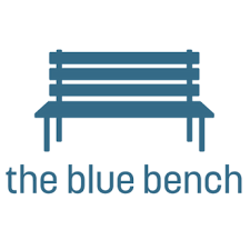 Logo of "the blue bench" with an illustration of a blue bench above the text.