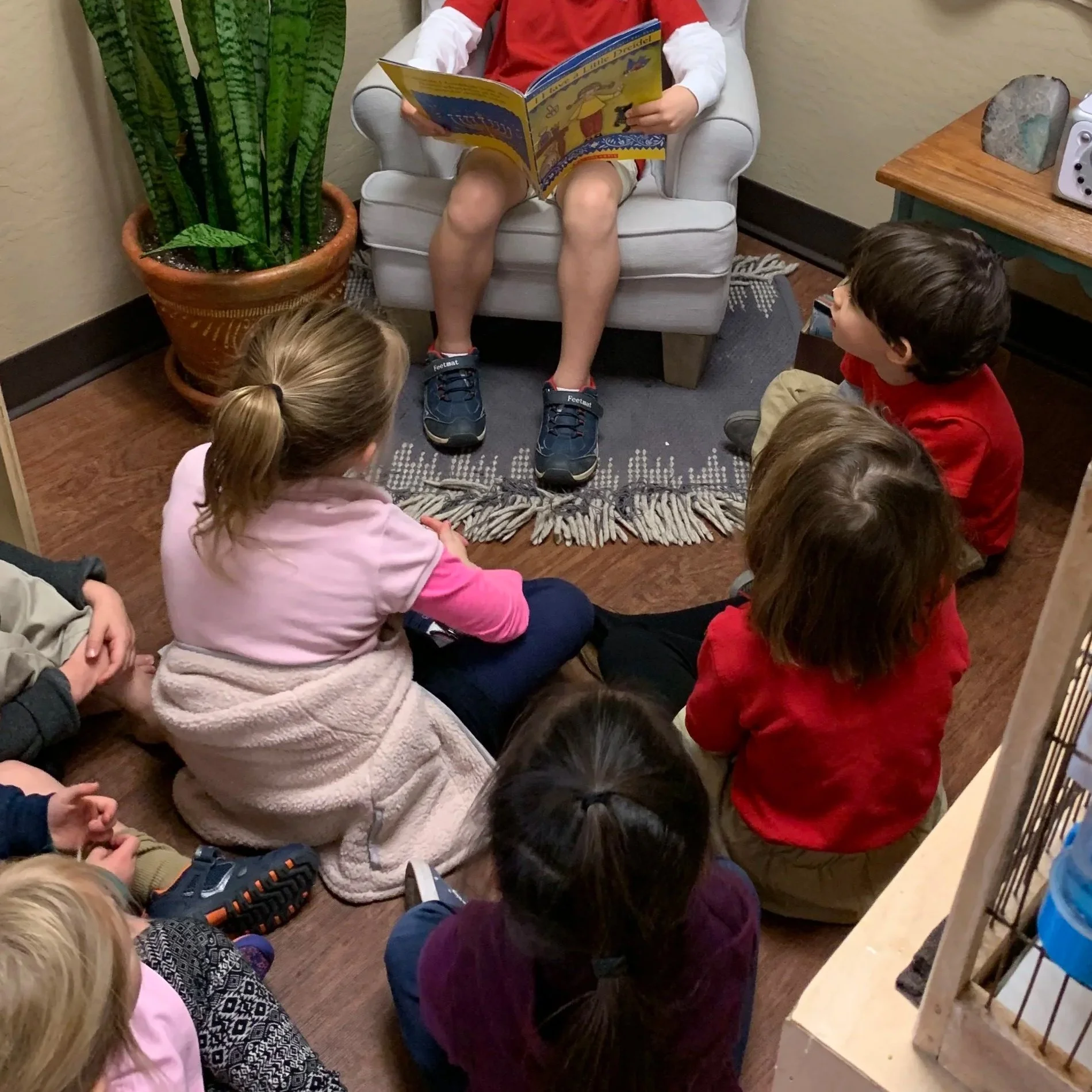 A child leads group time.