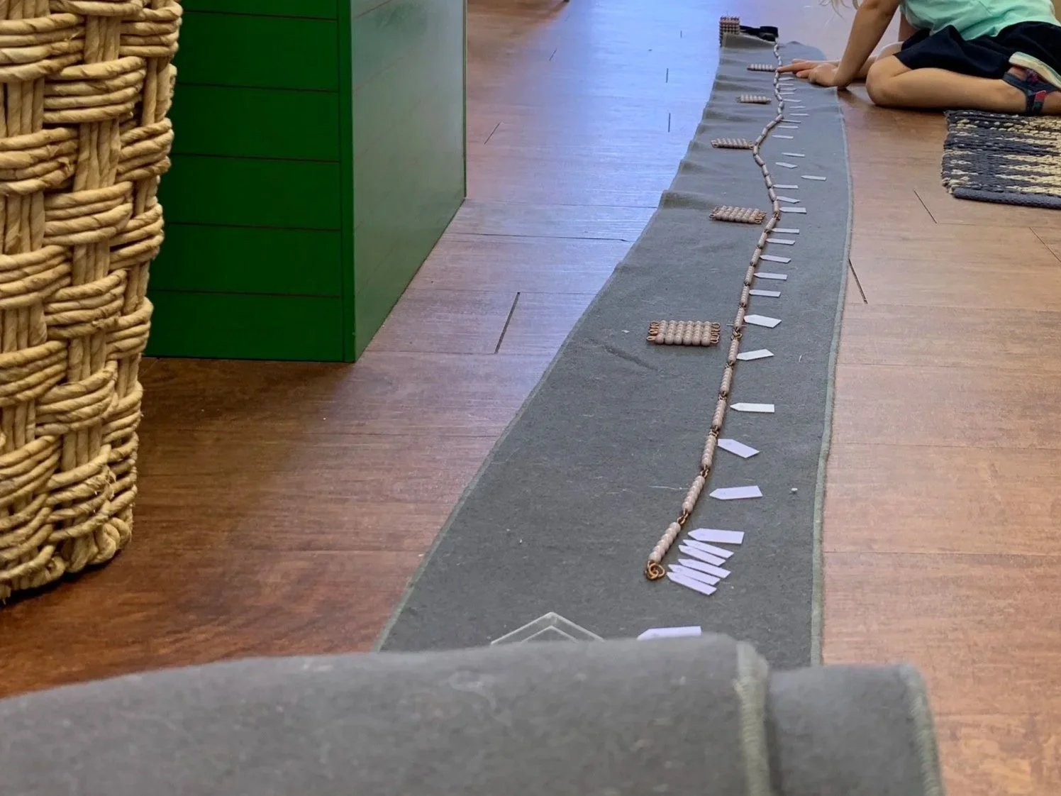  Second- and third-year students work with the long bead chains to practice skip counting and receive indirect preparation for squaring and cubing. They label each chain and compare them side by side, seeing quantity unfold before their eyes. This is