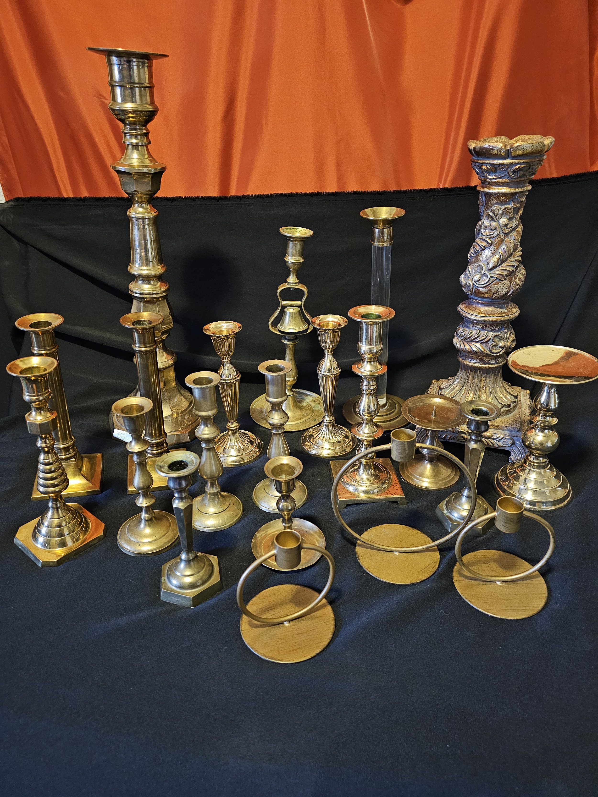 Eclectic brass candle sticks. Some vintage and brass. Some are brass colored one is resin wit brass/gold paint. 22 total in set. Tallest 19" - smallest 4"/ $45 for set