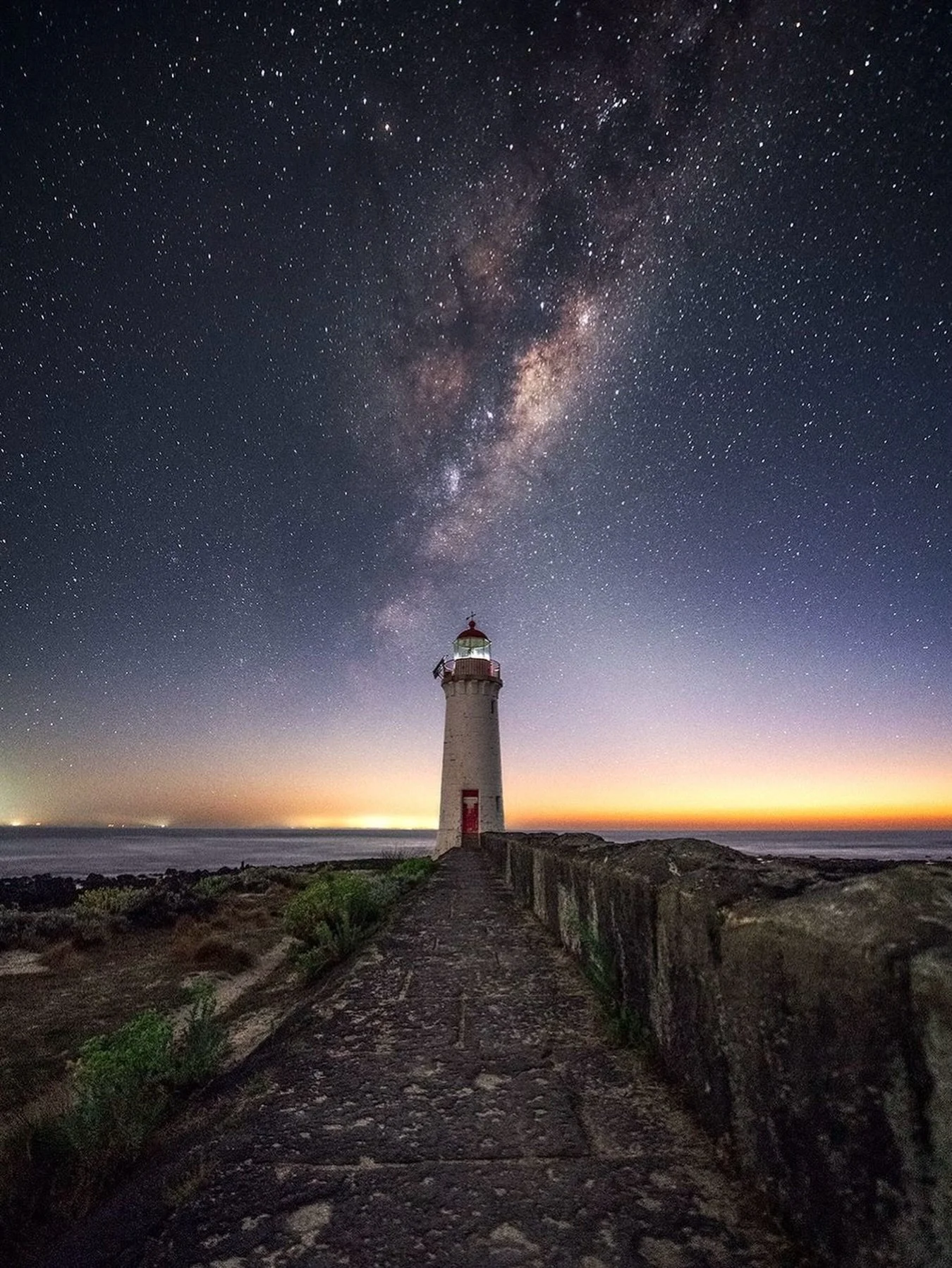 Griffiths Island Lighthouse 

Located in Port Fairy, Victoria, Australia. An amazing place for sunset, sunrise, and night photography. Or a combination of them. I took this shot just as the switch from night to day was happening and the Milky Way was