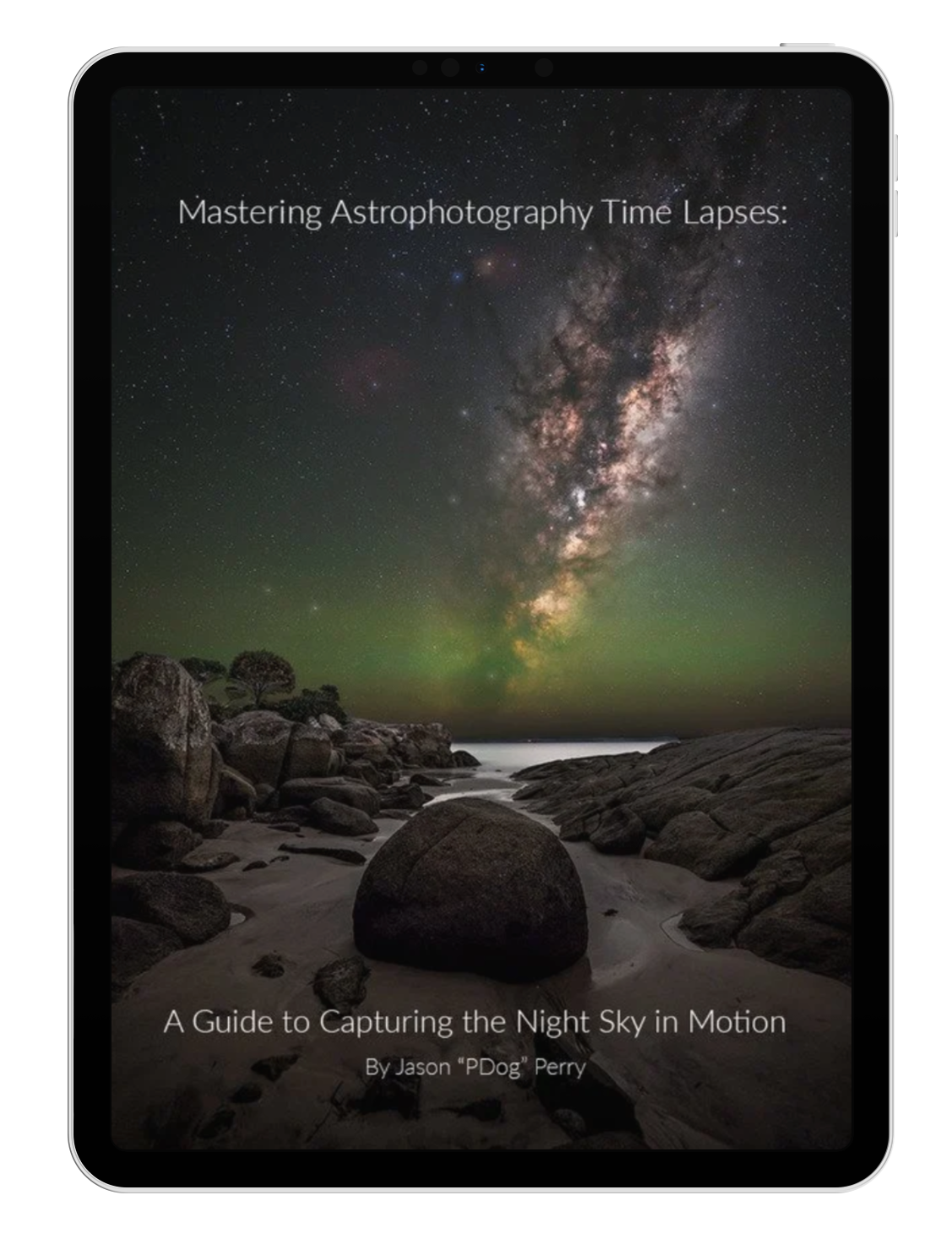 Book cover titled 'Mastering Astrophotography Time Lapses: A Guide to Capturing the Night Sky in Motion' by Jason 'PDog' Perry, featuring a night sky with the Milky Way galaxy, stars, and a faint green aurora over a rocky shoreline.