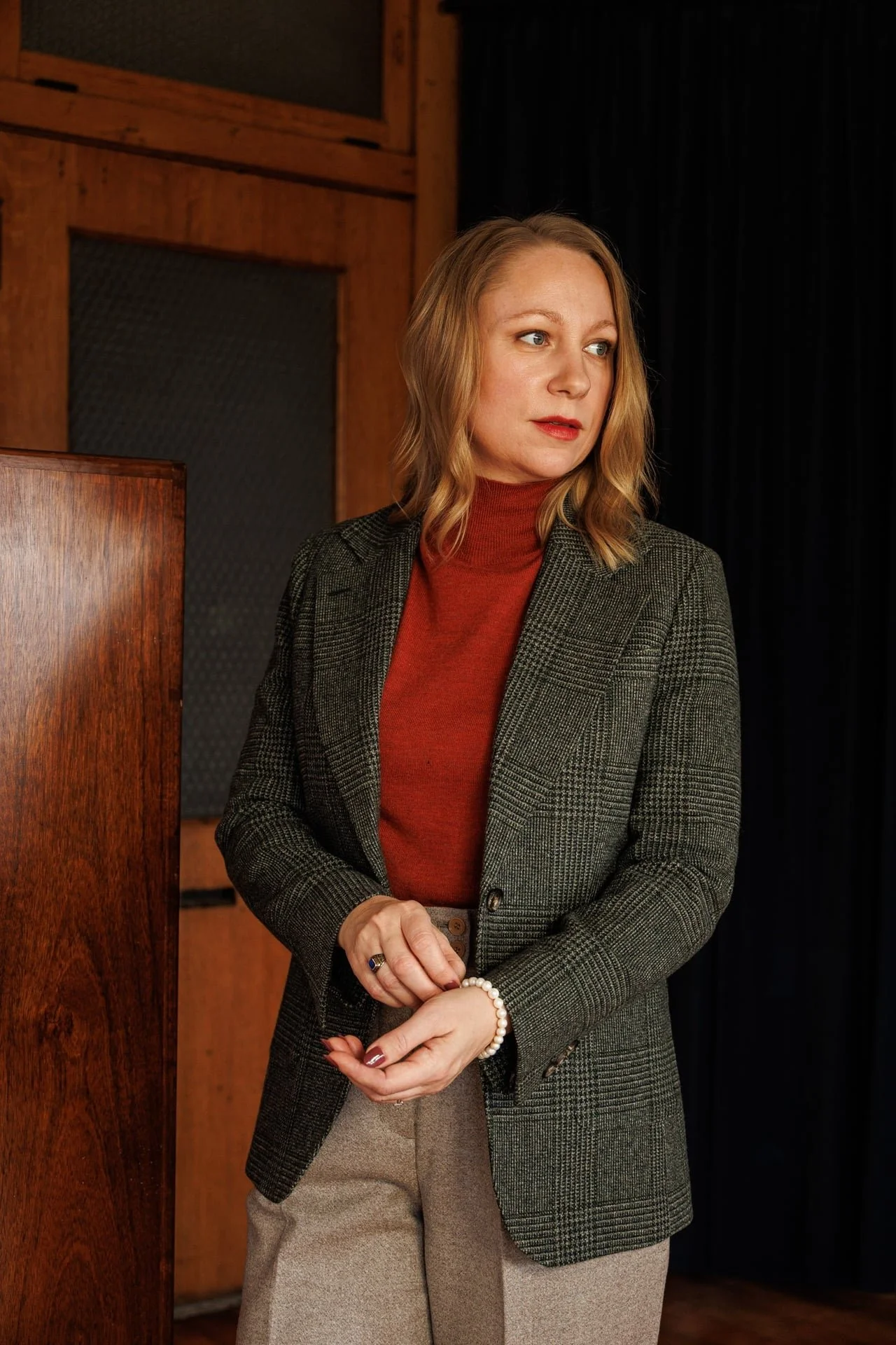 Amy Bayless suit with red turtleneck