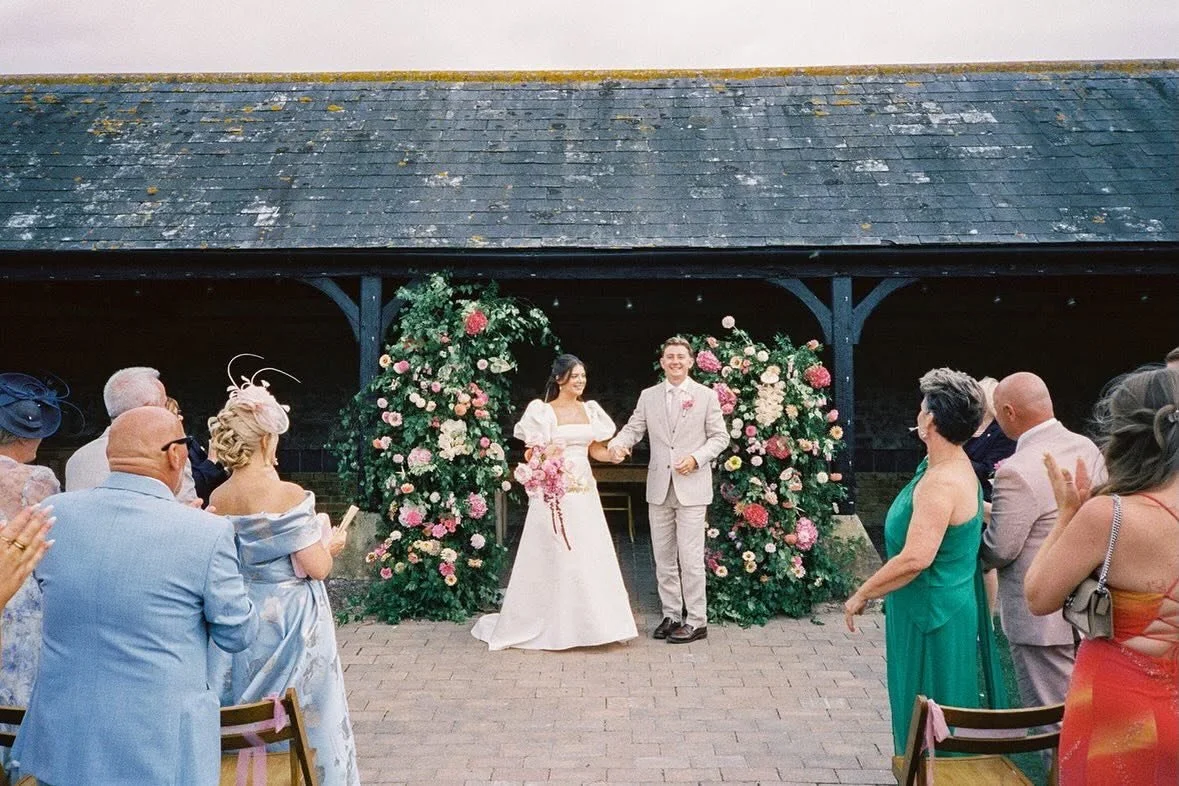 Such a magical ceremony area for Sophie &amp; Sam last August ✨🫶🏻🌸 

A floral arch with all the pinks and peaches and an absolute storm of locally sourced flowers from the farm and the most Devine tropical numbers.
Venue @elmleynature 
Florals @wh