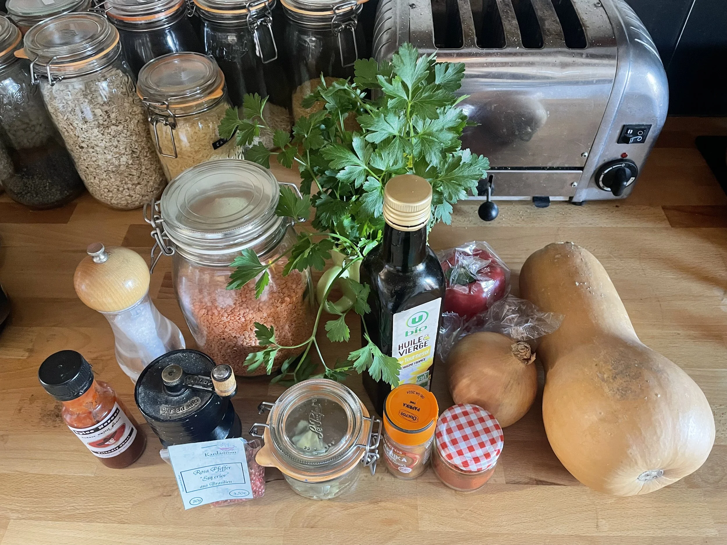 All the ingredients for a meal with butternut squash on a worktop