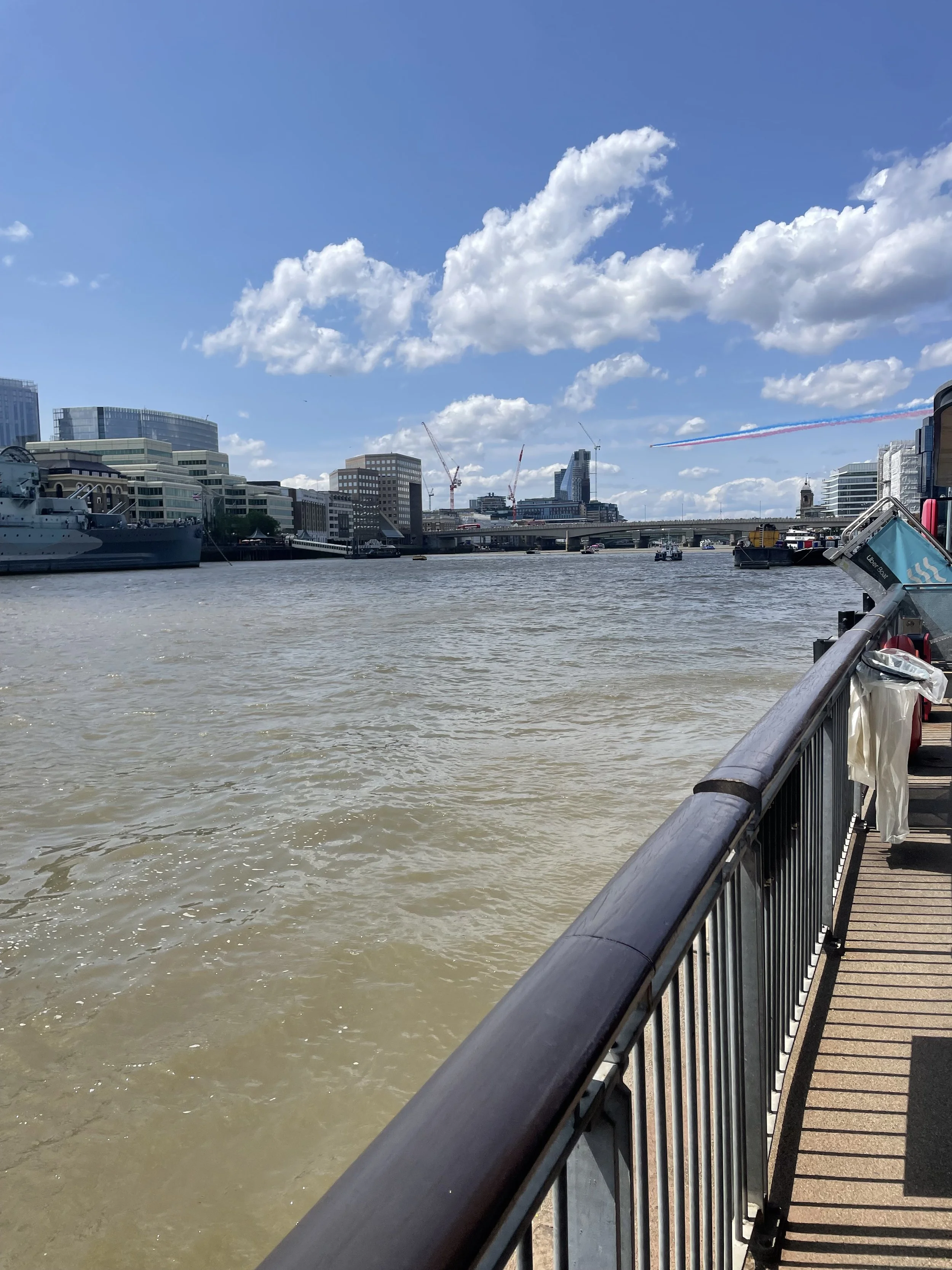 The Thames with the Red Arrows trailing red, white and blue smoke in the distance