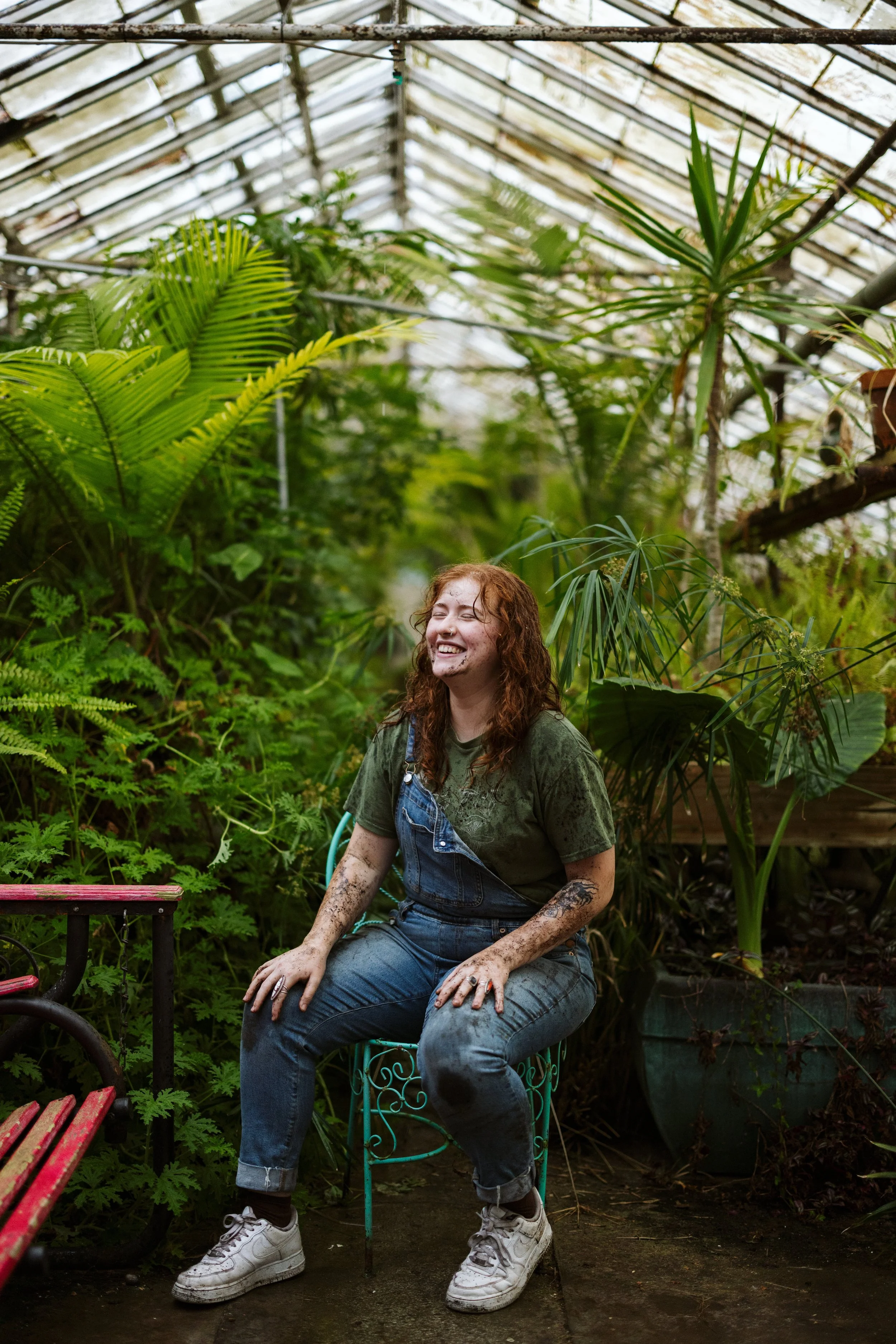 Amanda sitting in a greenhouse