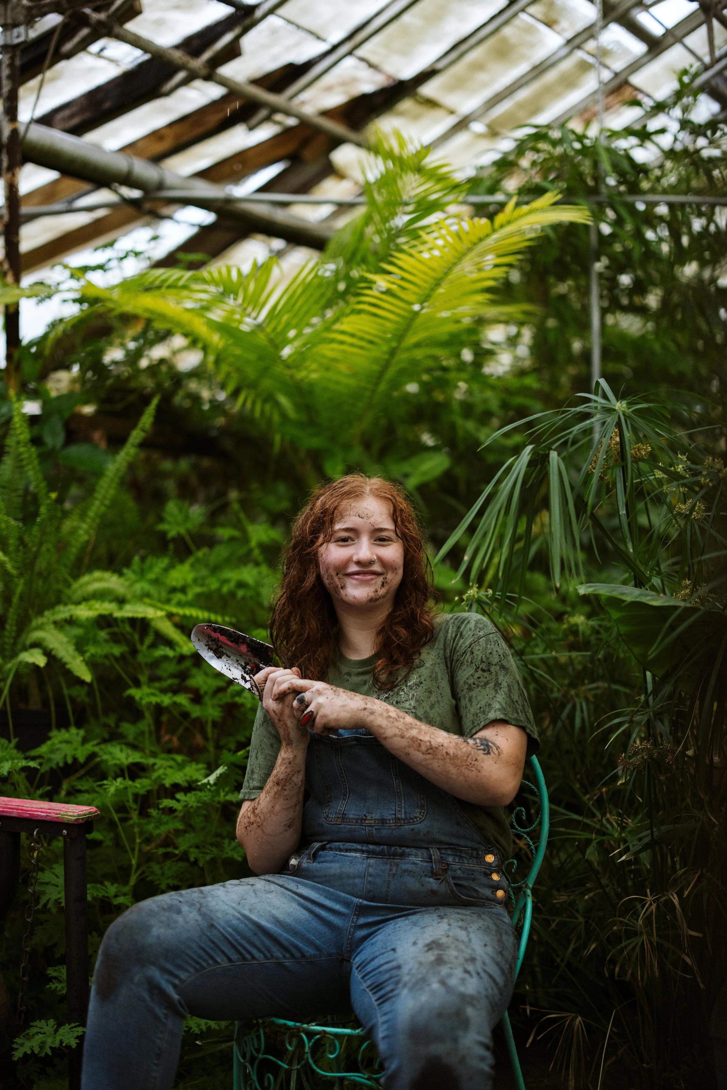 Amanda walking through a greenhouse holding insecticidal soap