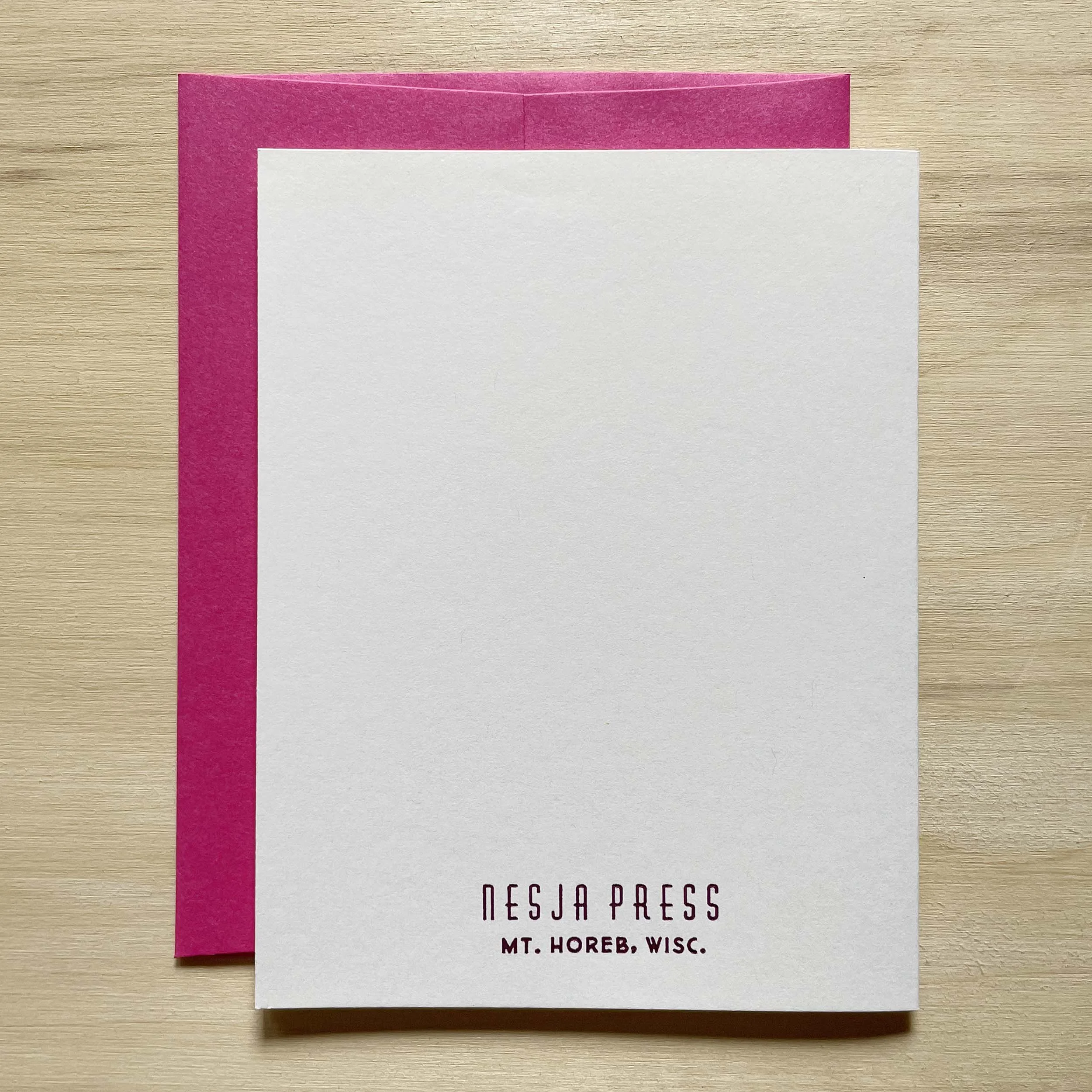 Folded card, closed, showing the back side with the Nesja Press logo and Mt. Horeb, Wisc. letterpress printed in small type near the bottom of the card.