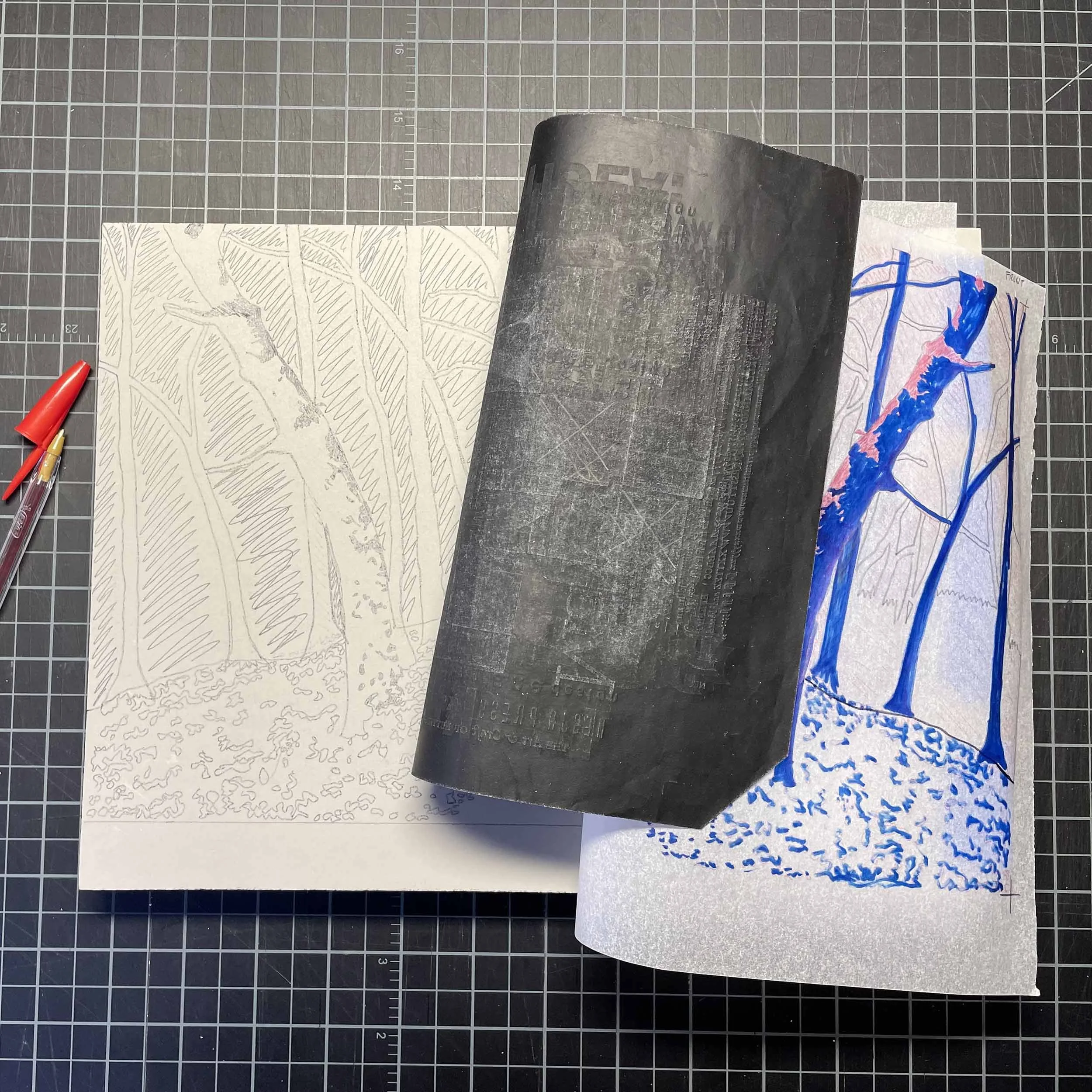 A light gray linoleum block has tree imagery drawn on it. The photo reveals how the artist transferred the drawing to the block, using a red ball point pen and carbon paper.