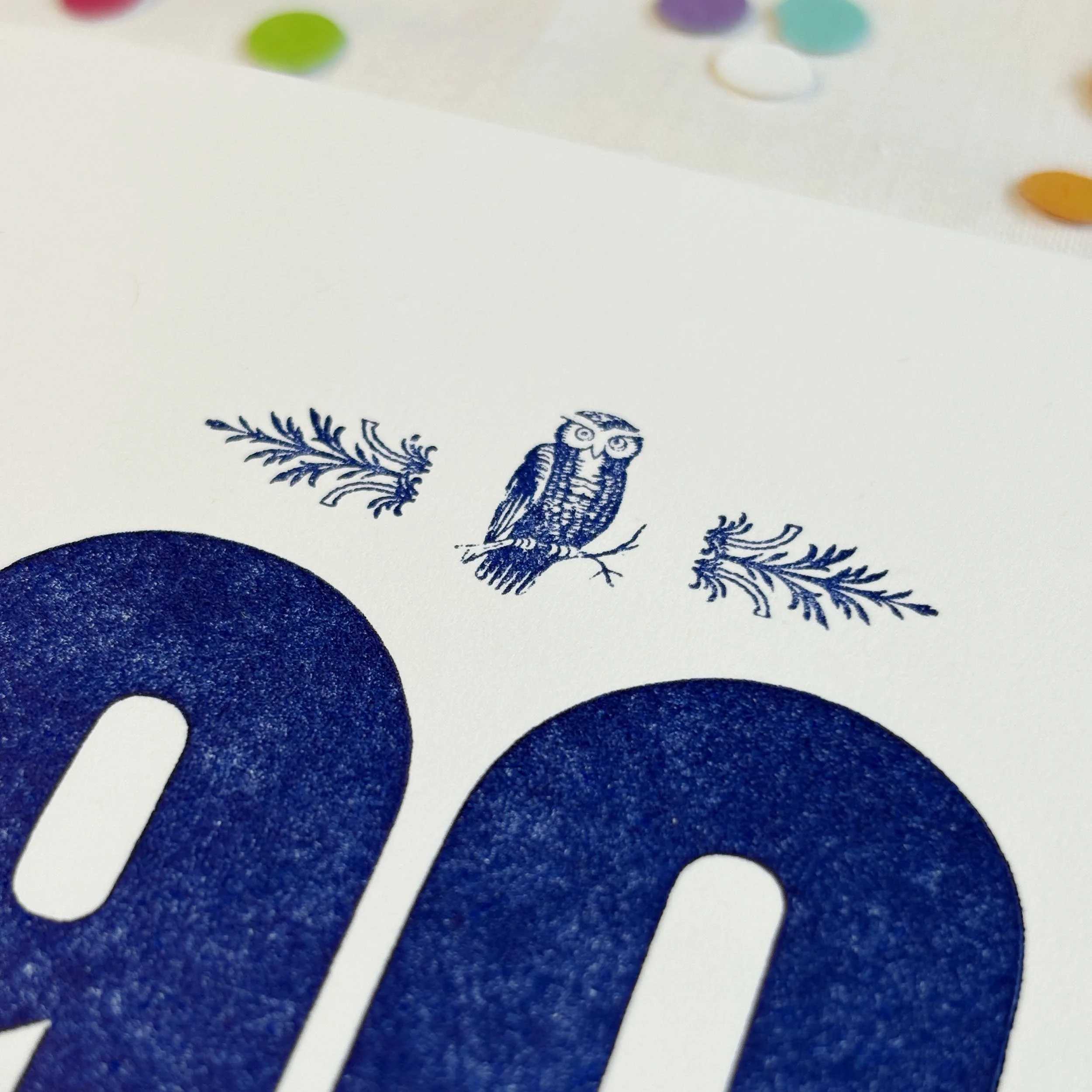 Detail of the wise old owl above the number 90.
