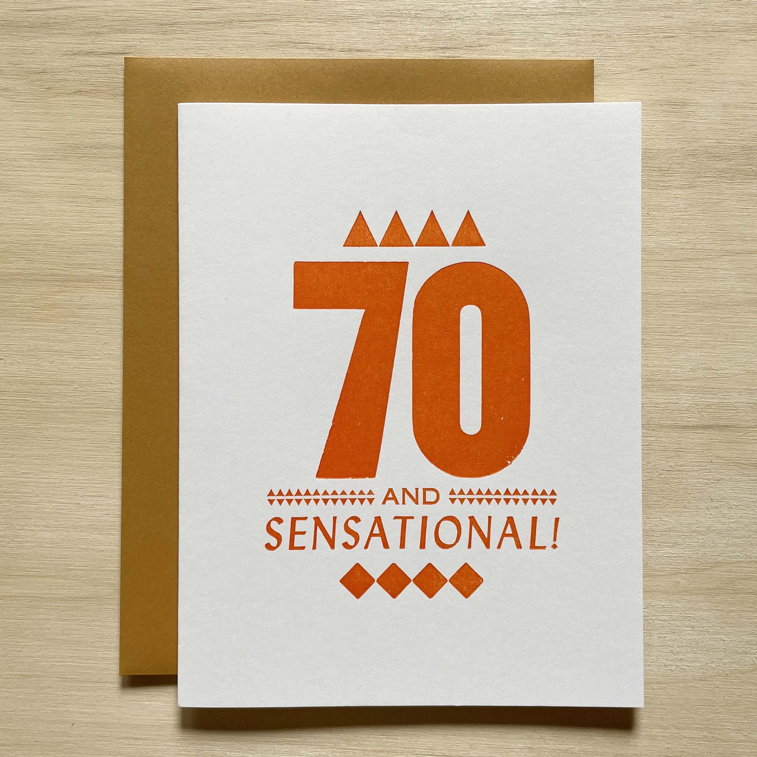 70 and Sensational card features a bold 70 with smaller words AND SENSATIONAL. Letterpress ornaments add decoration. Orange ink on white paper. Orangey brown envelope.