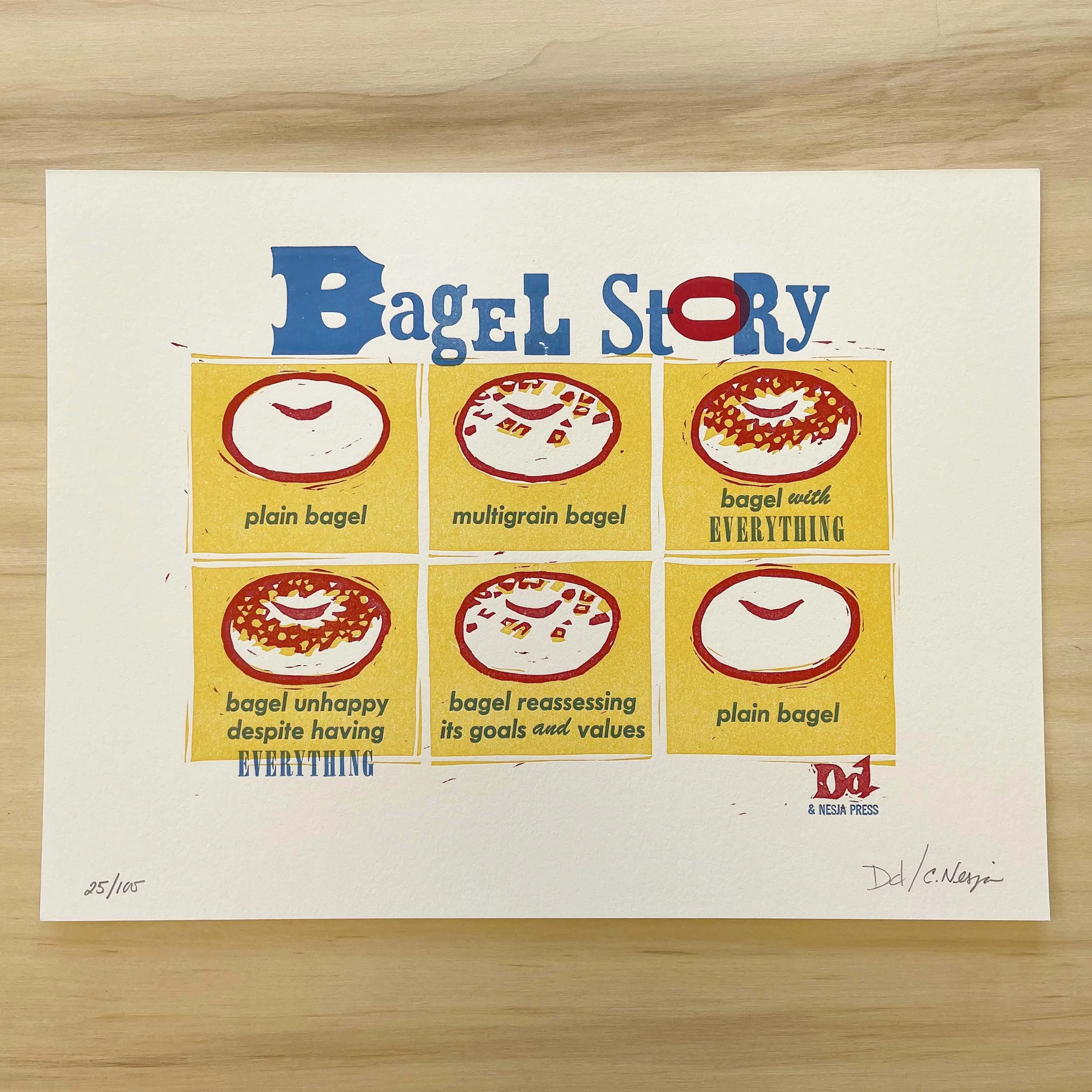 A six-panel linocut comic follows a bagel’s life: plain, multigrain, with EVERYTHING, unhappy with everything, reassessing its values—before returning full circle to plain bagel. Signed and numbered.