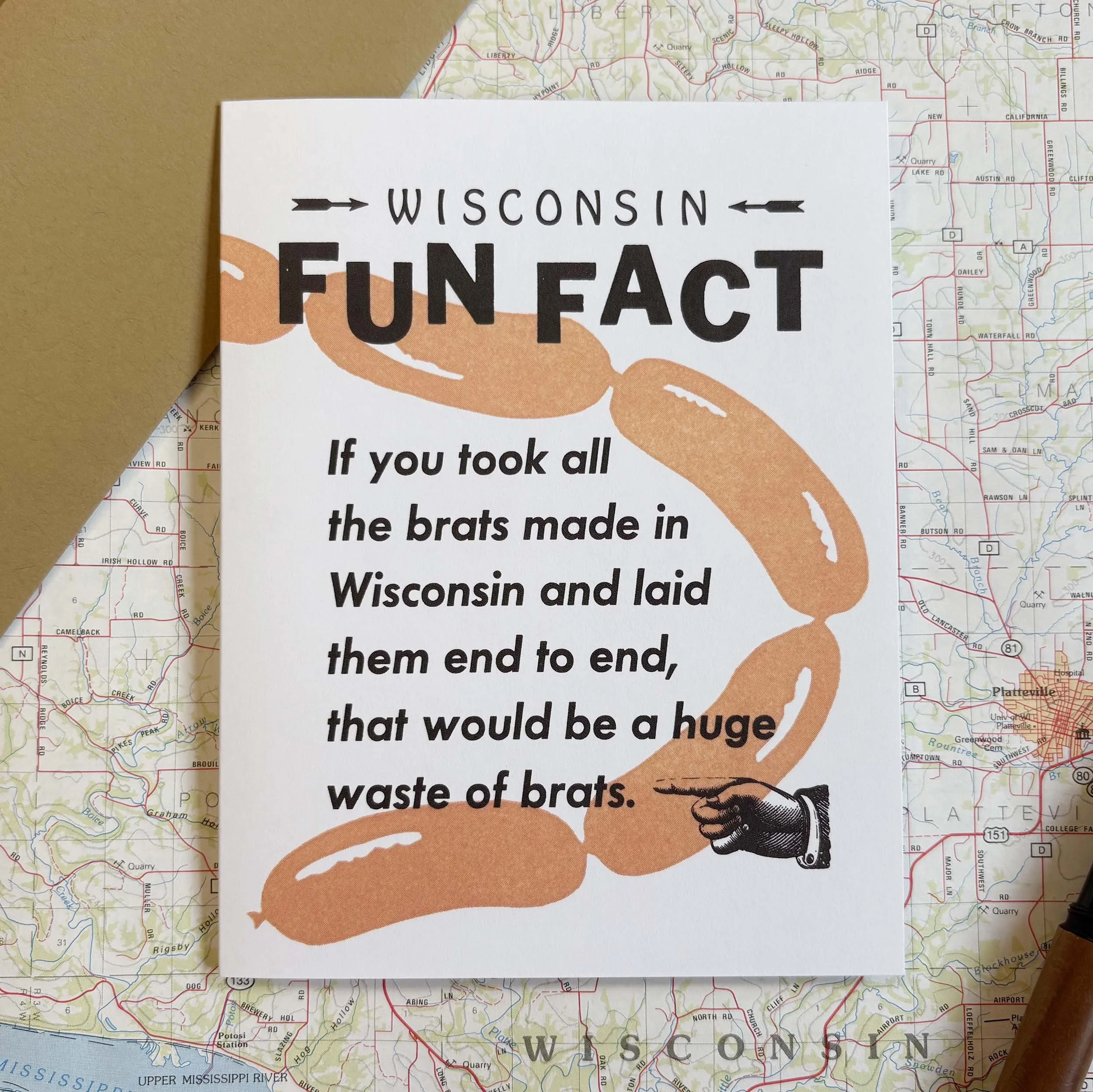 Wisconsin Fun Fact, If you took all the brats made in Wisconsin and laid them end to end, that would be a huge waste of brats. Kraft paper brown envelope.