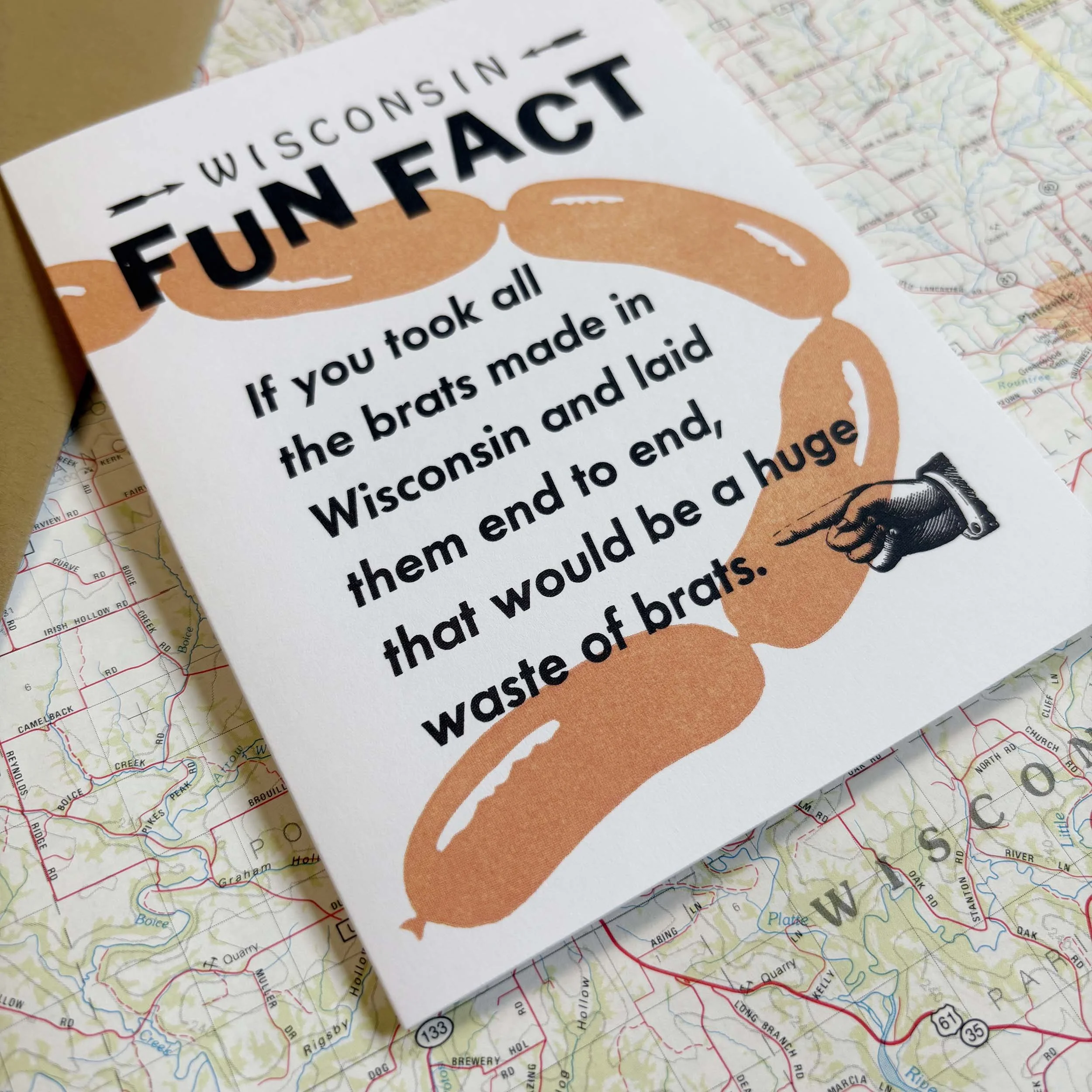 Wisconsin Fun Fact, If you took all the brats made in Wisconsin and laid them end to end, that would be a huge waste of brats. Kraft paper brown envelope.