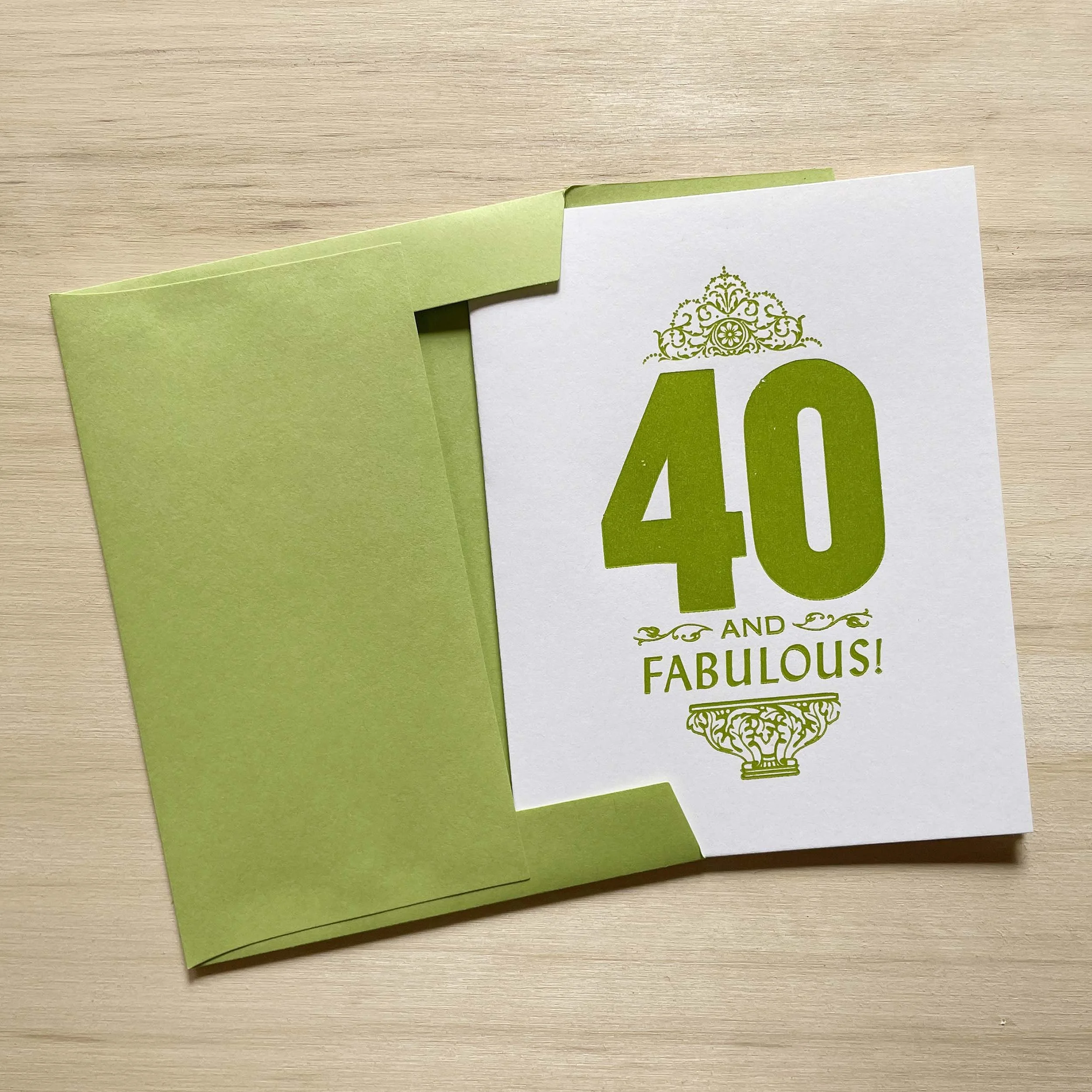 40 and Fabulous card features a bold 40 with smaller words AND FABULOUS. Letterpress ornaments add decoration. Green ink on white paper. Green envelope.