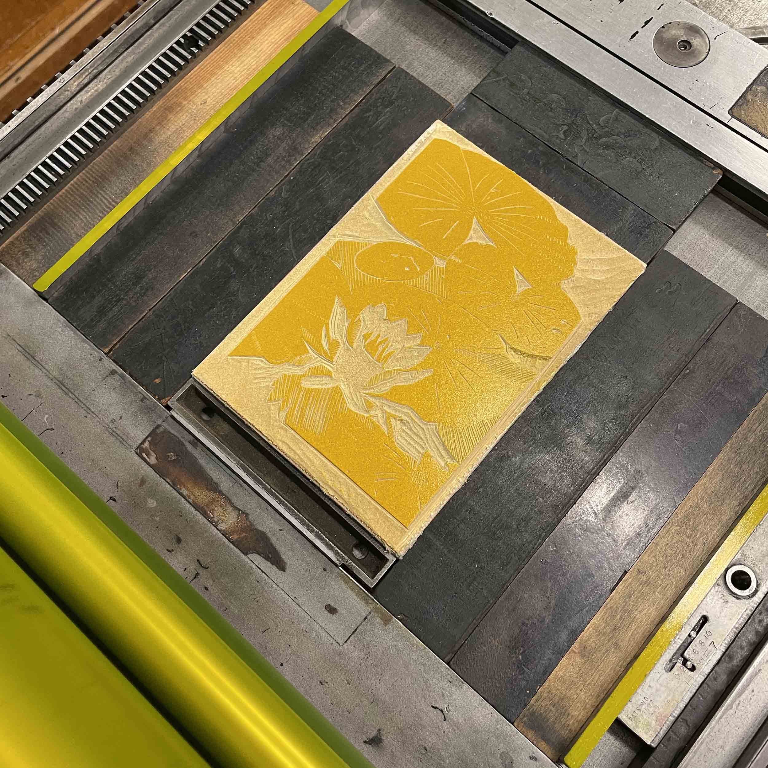 Mirror Lake Lily Linocut block 1 on press