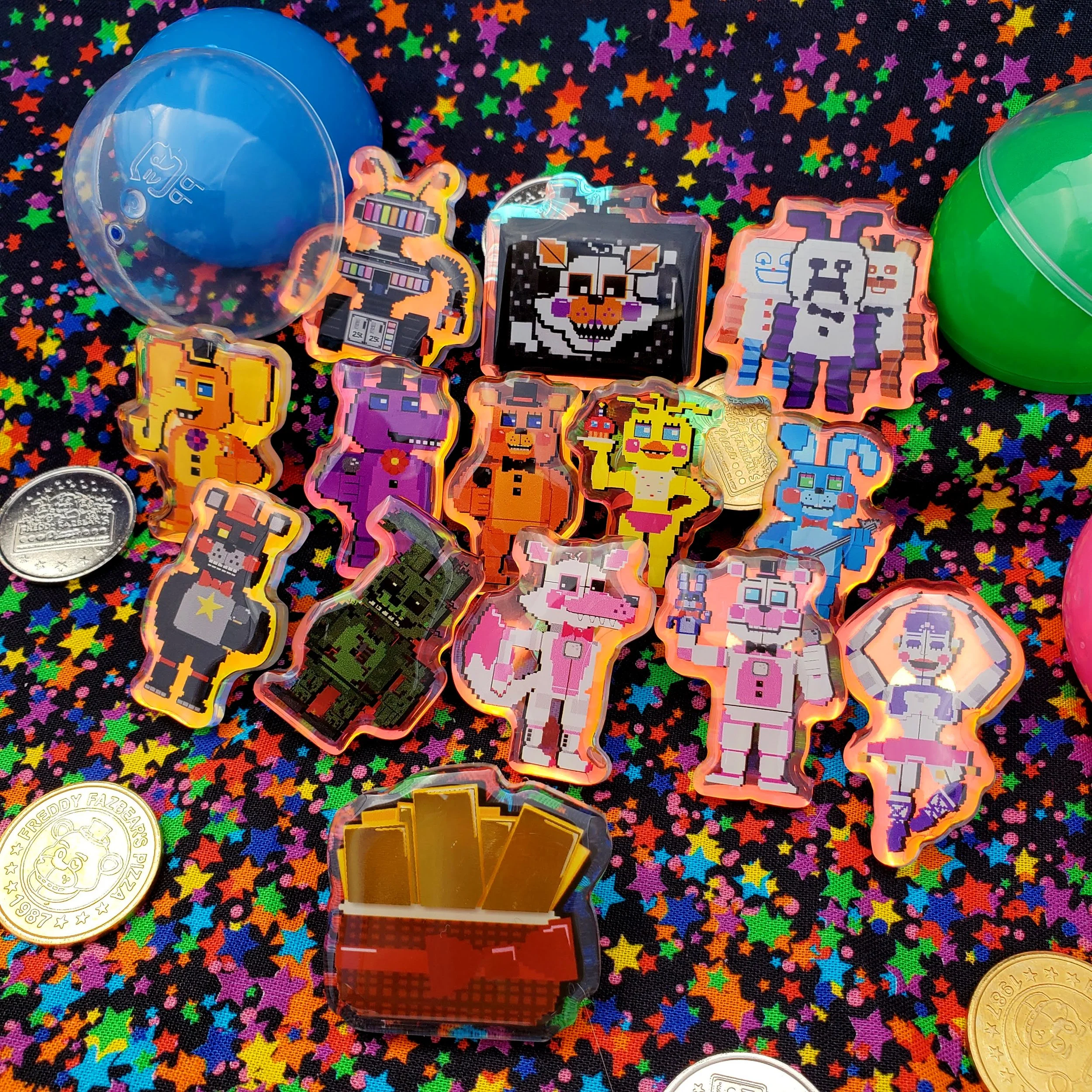 Pixel art characters in various colors and designs on a black star-patterned background, surrounded by plastic capsules and coins.