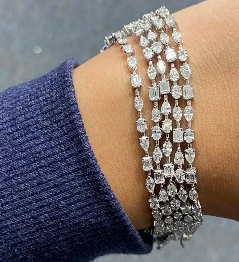 Hourglass Diamonds diamond bracelets with pear, marquise, and emerald cuts on the wrist.