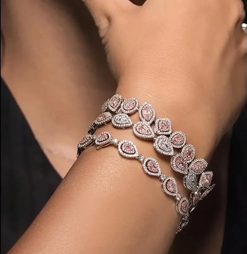 Two bracelets from Hourglass Diamond featuring pear-shaped pink diamonds set in platinum.