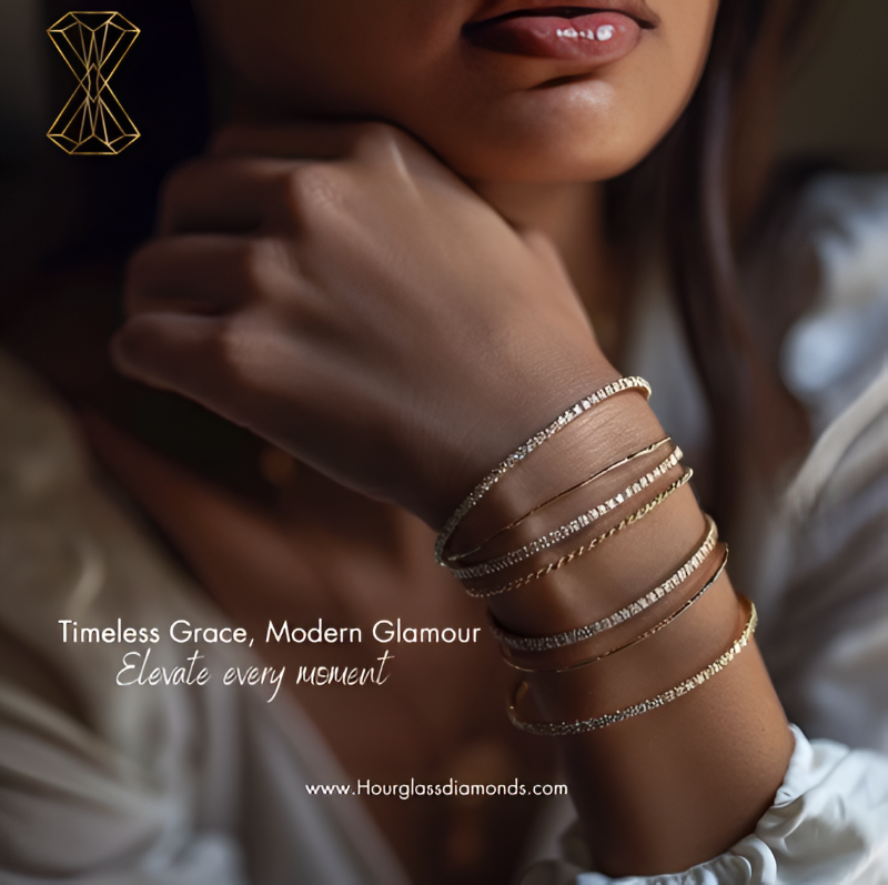 A woman's wrist wearing multiple stacked diamond and gold tennis bracelets and bangles from Hourglass Diamonds.