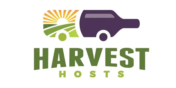 Logo of Harvest Hosts featuring a stylized RV with a sun and field design, and the text 'HARVEST HOSTS' in green.