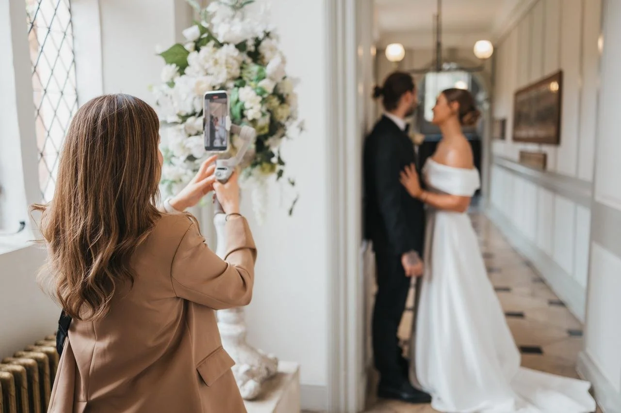 Wedding content creator capturing behind-the-scenes moments and vertical video at a luxury wedding