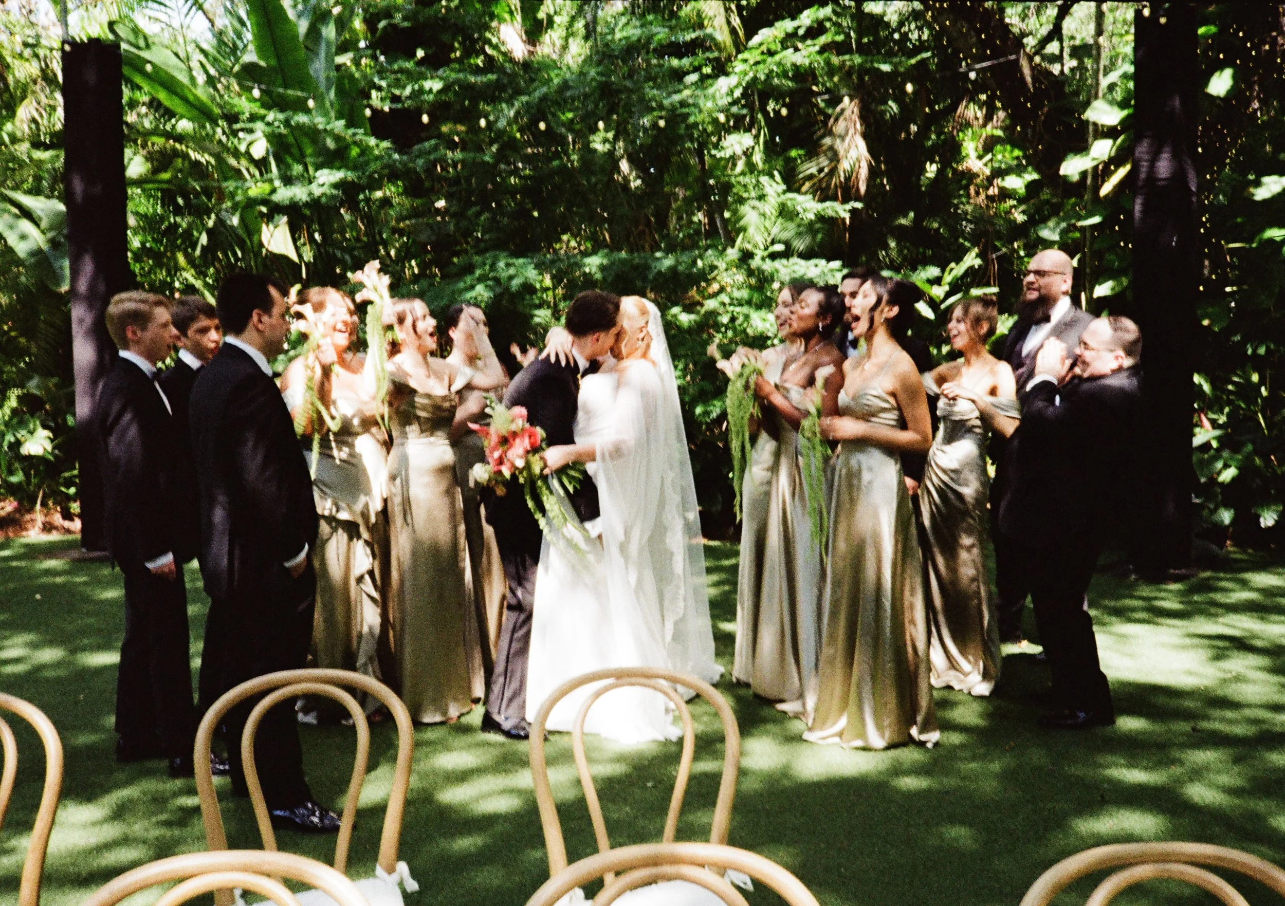 Wedding party shots including bridesmaids in olive green dresses and cascading bouquets