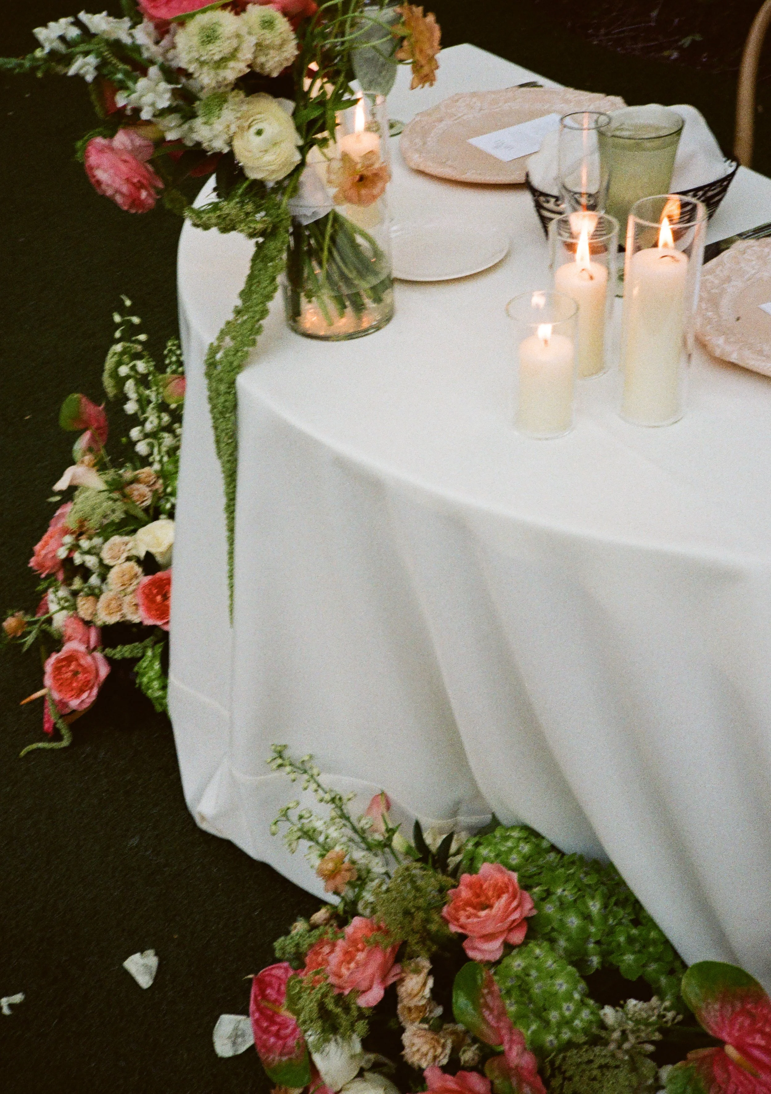 Bride and Groom Sweetheart table decorated with pastel garden-style floral arrangements at at a luxury wedding venue in Miami.