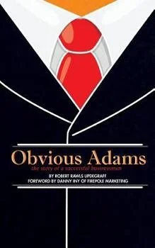 Book cover for "Obvious Adams" featuring an illustration of a man in a suit with a white shirt, red tie, and black jacket.